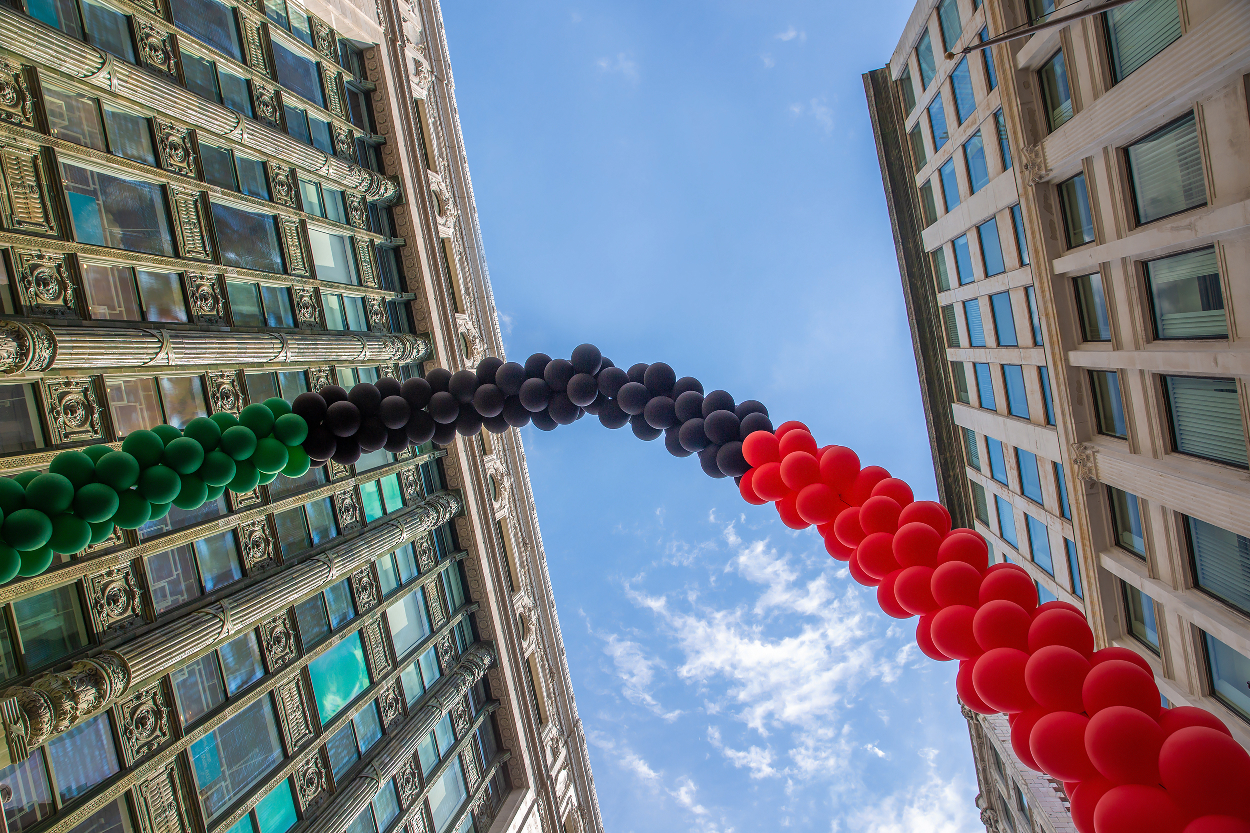 An archway of balloons in the colors of the Black Liberation African American Flag on Juneteenth National Independence Day.