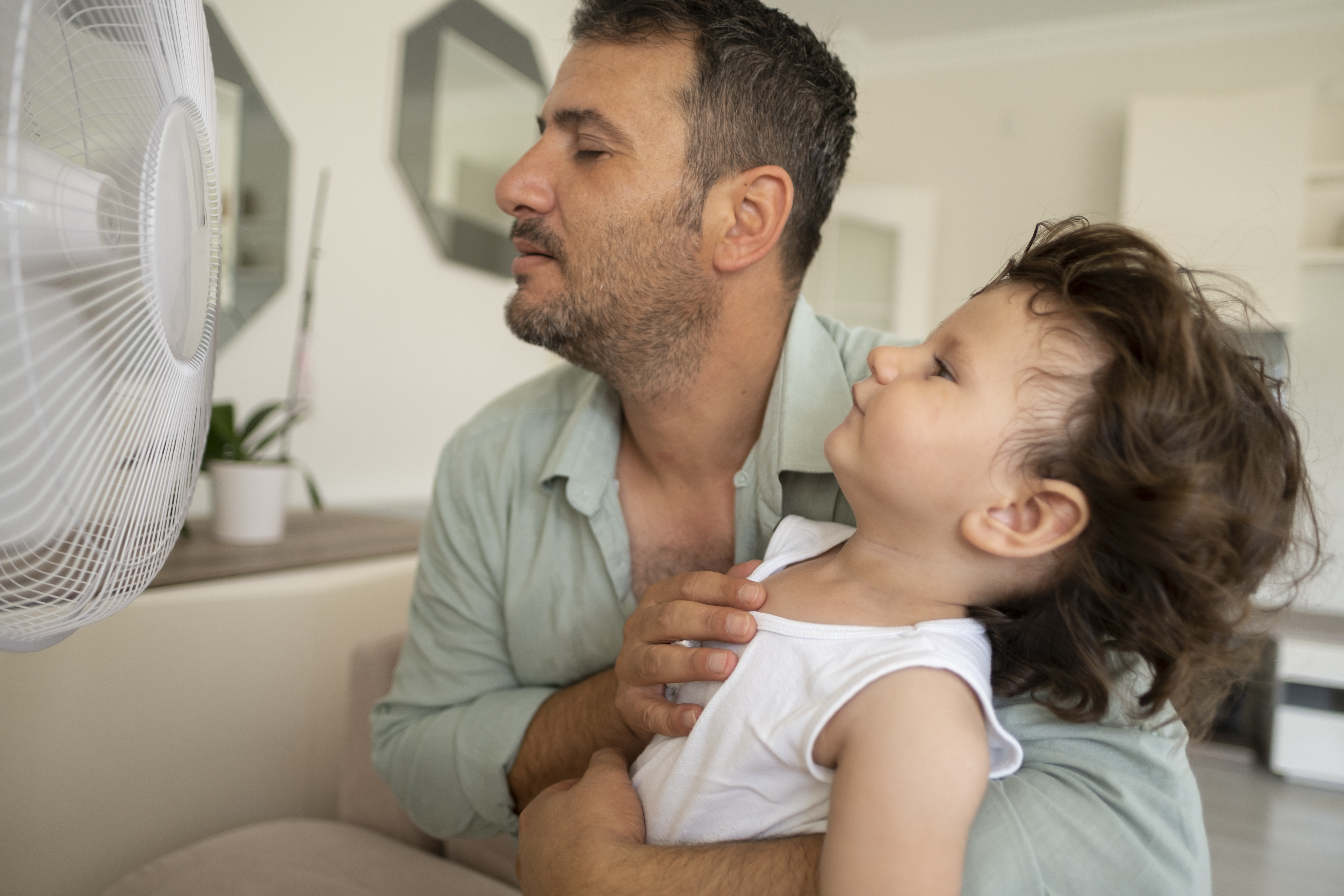 father and child with fan