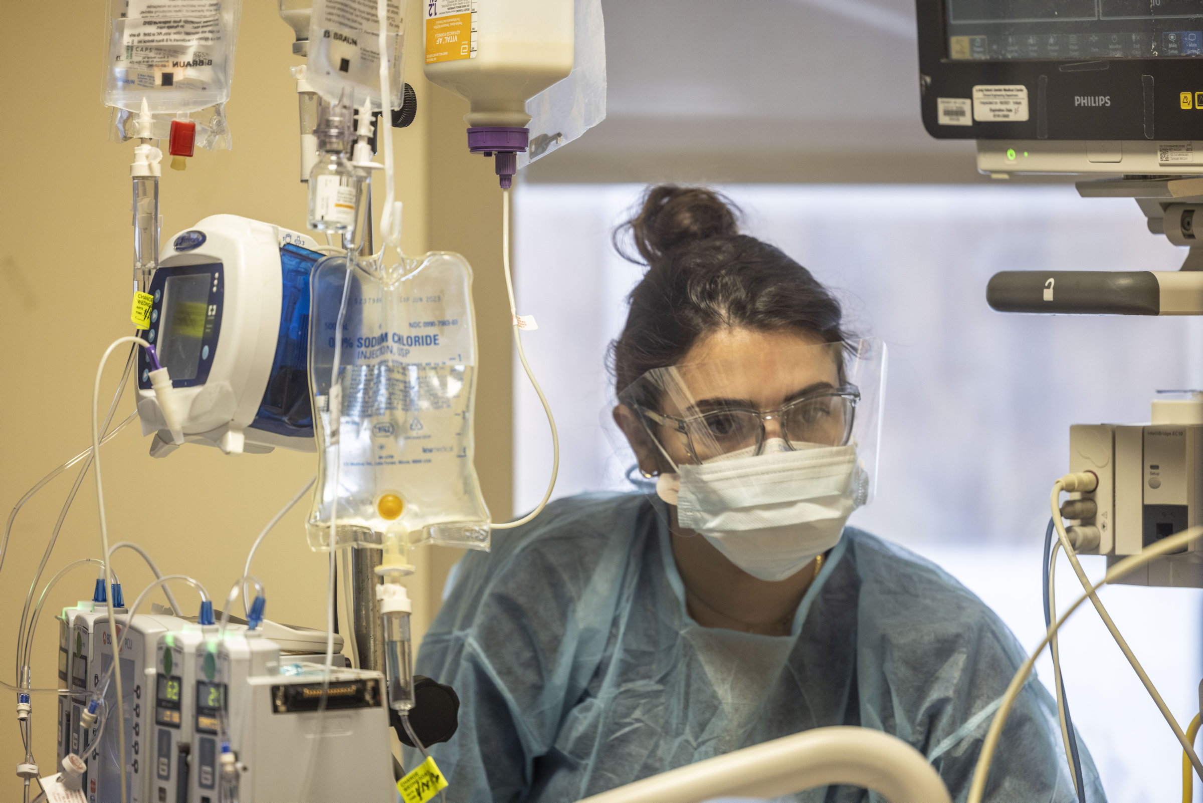 A nurse checks on a patient in intensive care in New Hyde Park, N.Y.