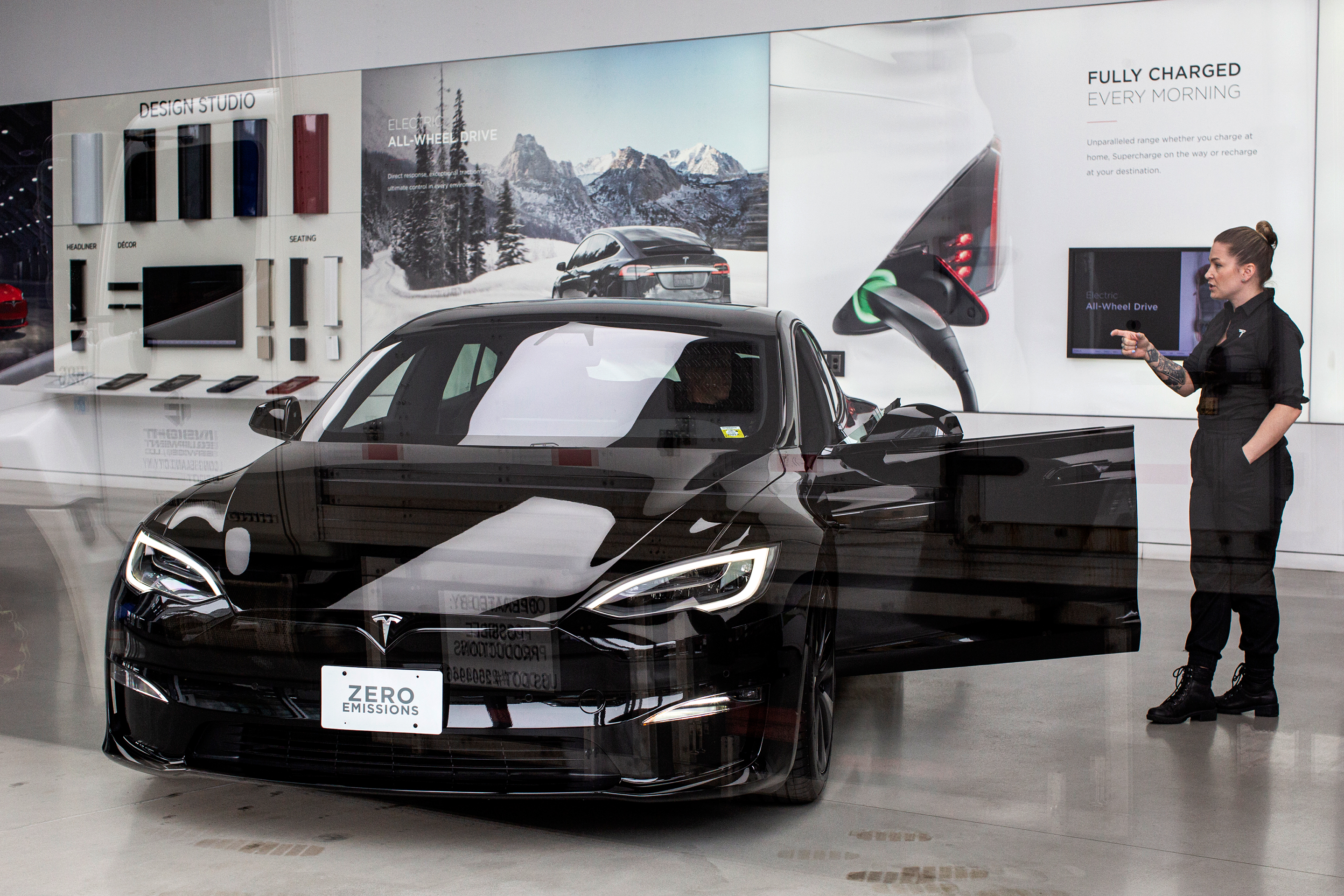 Tesla employee talks to a customer inside Tesla's showroom in New York City.