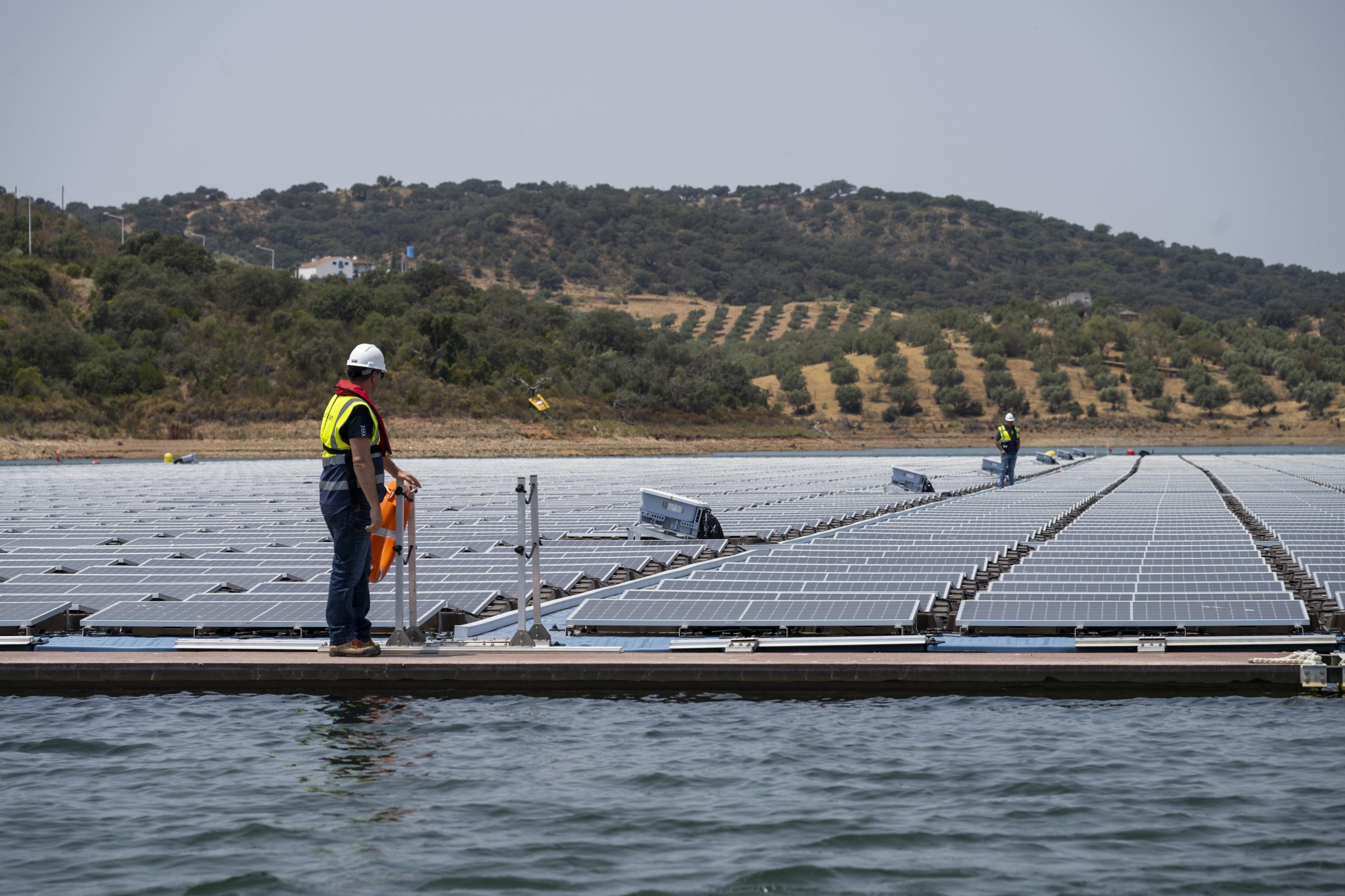 Workers at a floating solar farm in Portugal
