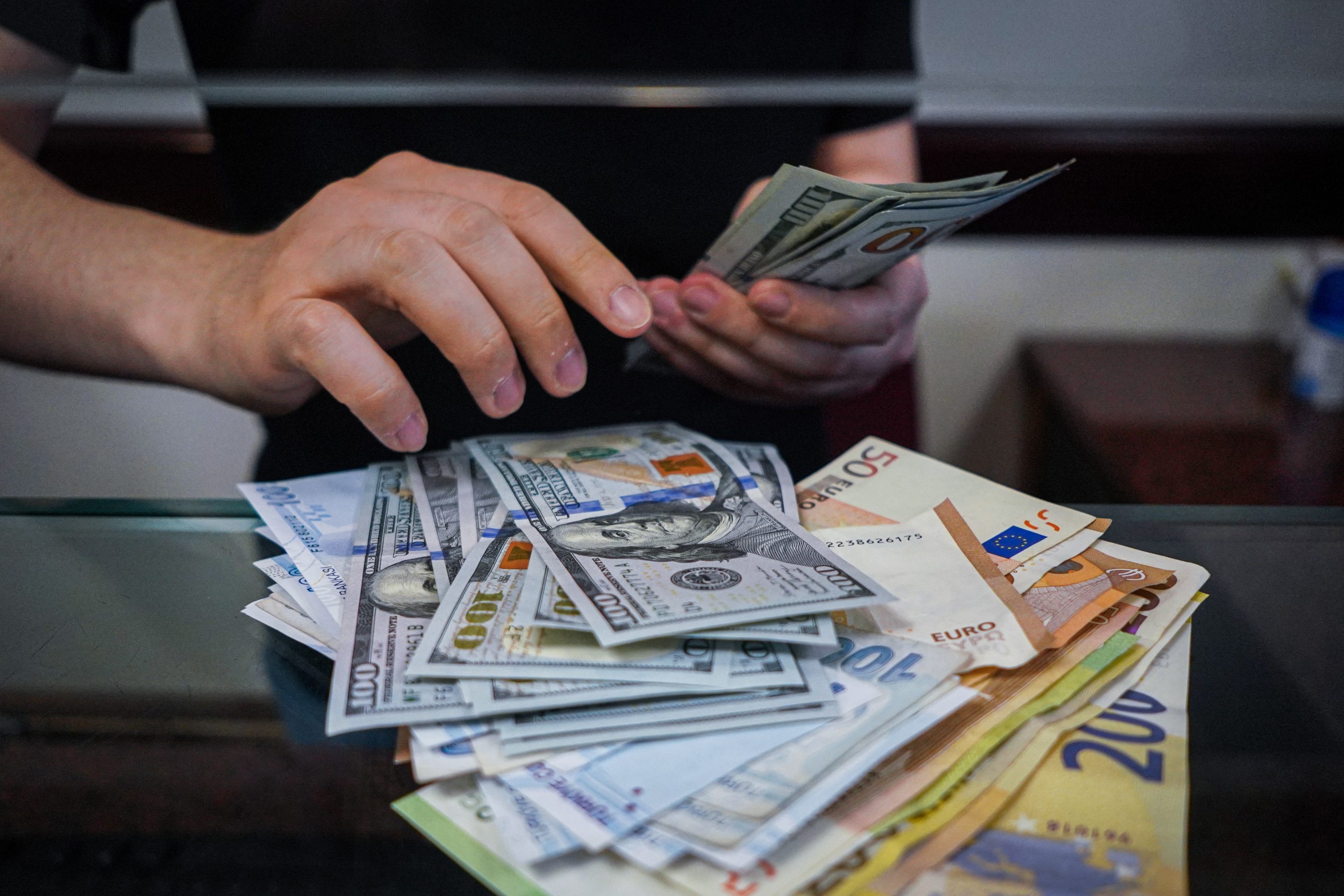Euros and dollars begin counted.