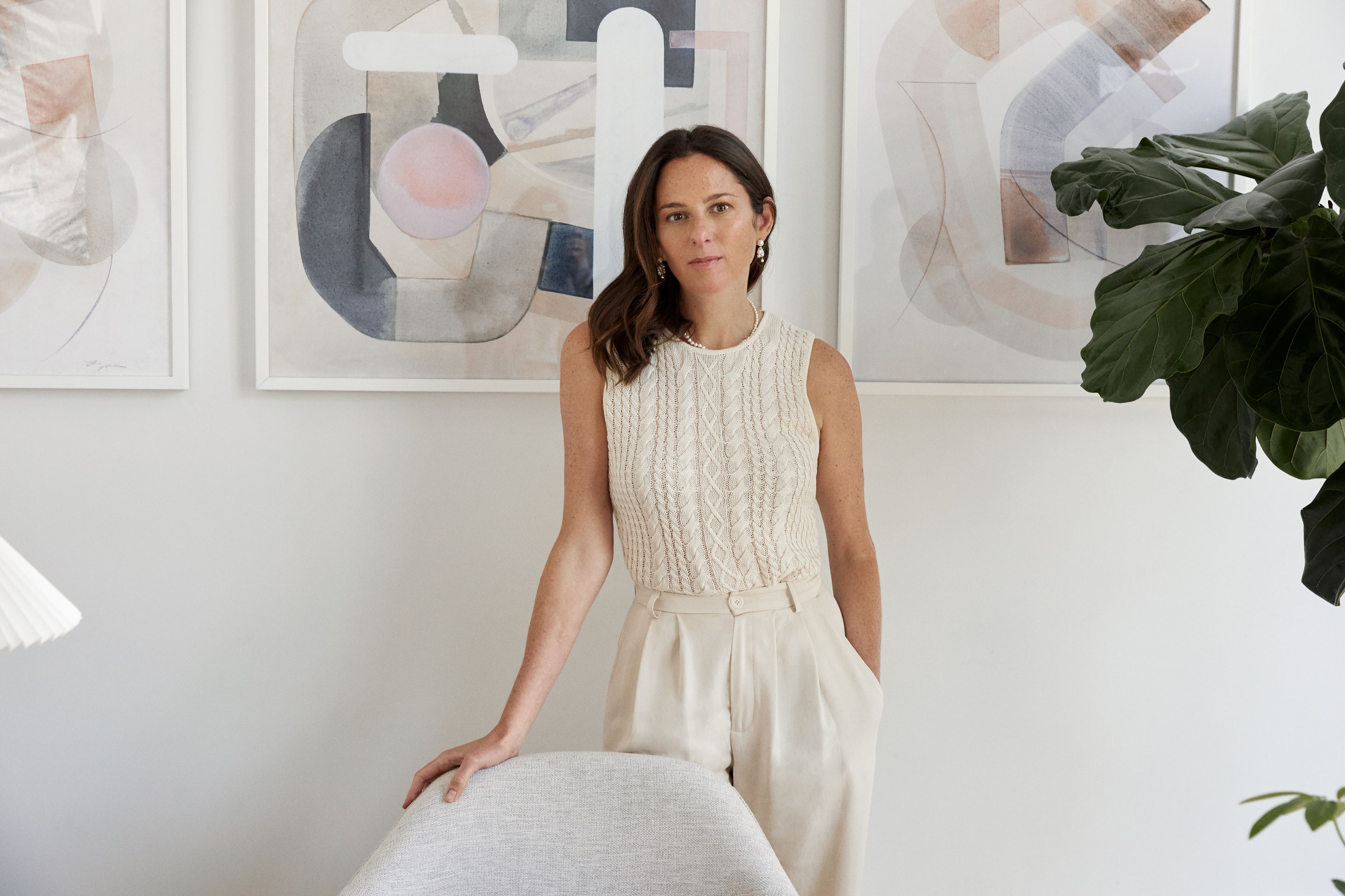 Reformation CEO Hali Borenstein standing behind a chair.