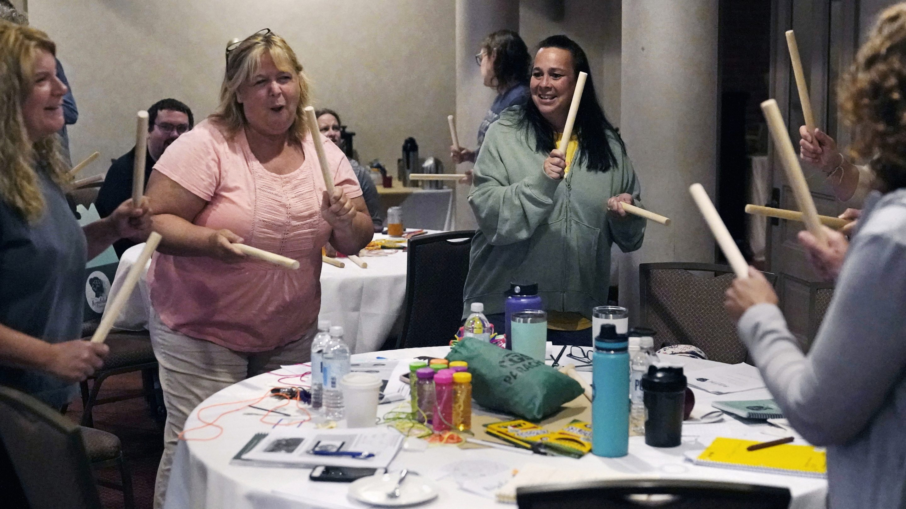 Teachers and guidance counselors tap wooden sticks during a rhythm exercise during a workshop helping teachers find a balance in their curriculum while coping with stress and burnout in the classroom Aug. in Concord, N.H. School districts around the country are starting to invest in programs aimed at address the mental health of teachers. Faced with a shortage of educators and widespread discontentment with the job, districts are hiring more therapist, holding trainings on self-care and setting up system to better respond to a teacher encountering anxiety and stress.
