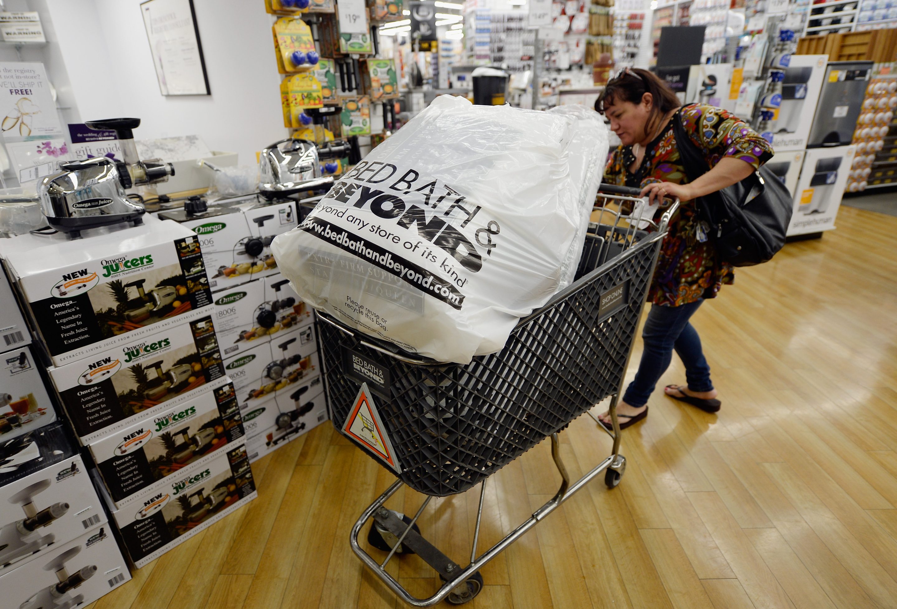 Customers carry bags from Bed Bath & Beyond store on April 10, 2013 in Los Angeles, California.