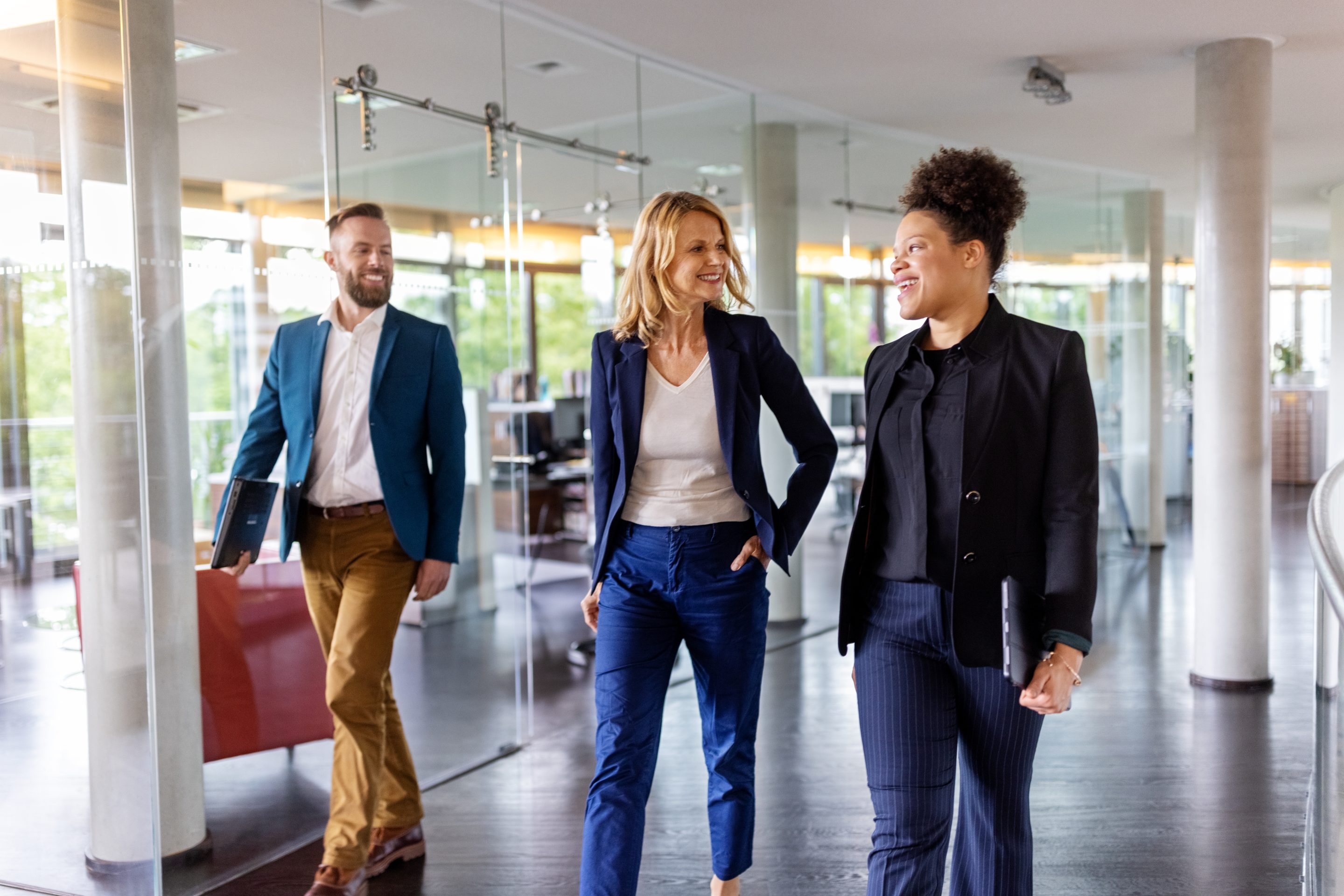 Smiling employees walking in office
