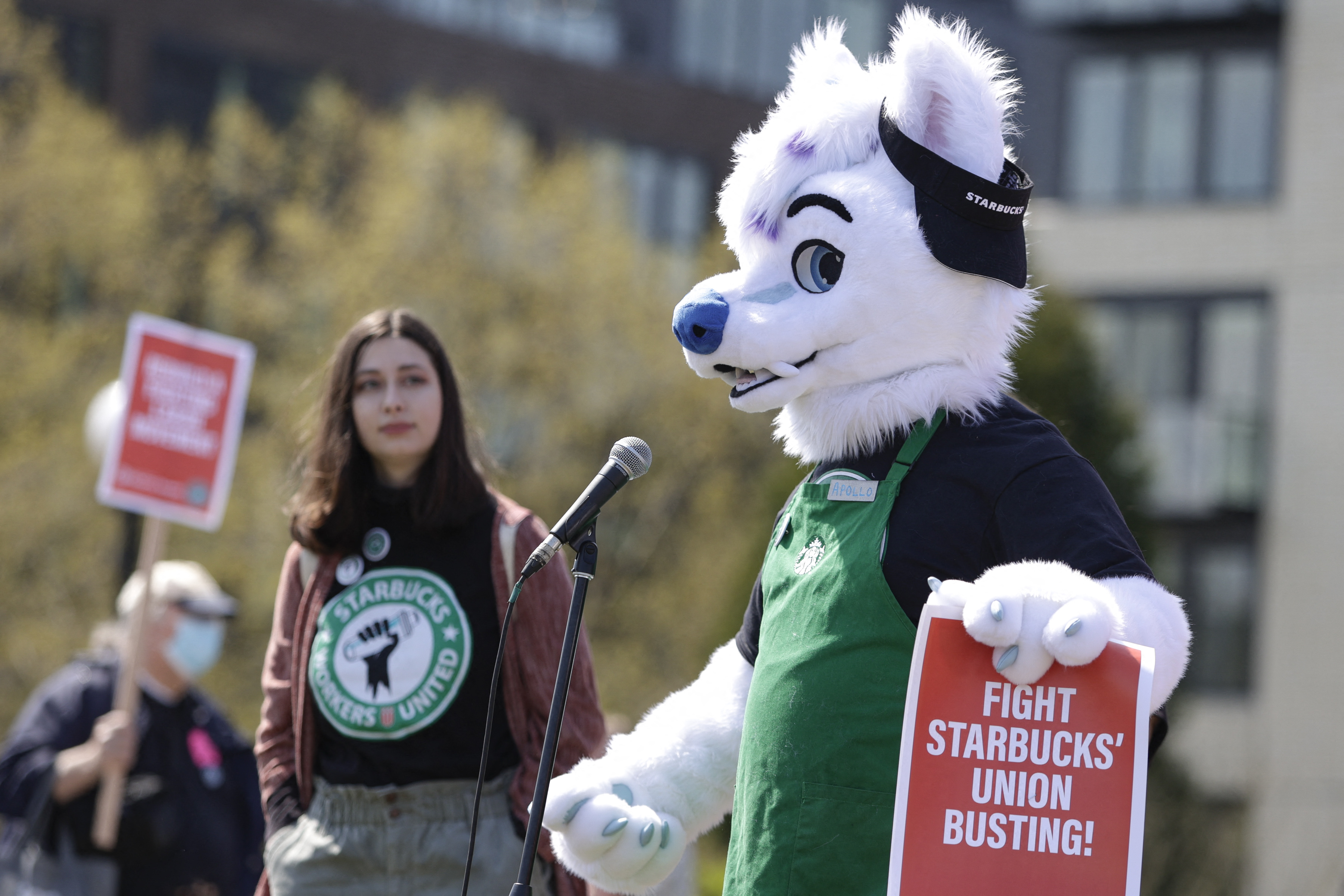 Michael Vestigo of Kansas City, Kansas, who claims he was fired by Starbucks, speaks while dressed as Apollo the wolf during the "Fight Starbucks' Union Busting" rally and march in Seattle on April 23, 2022.