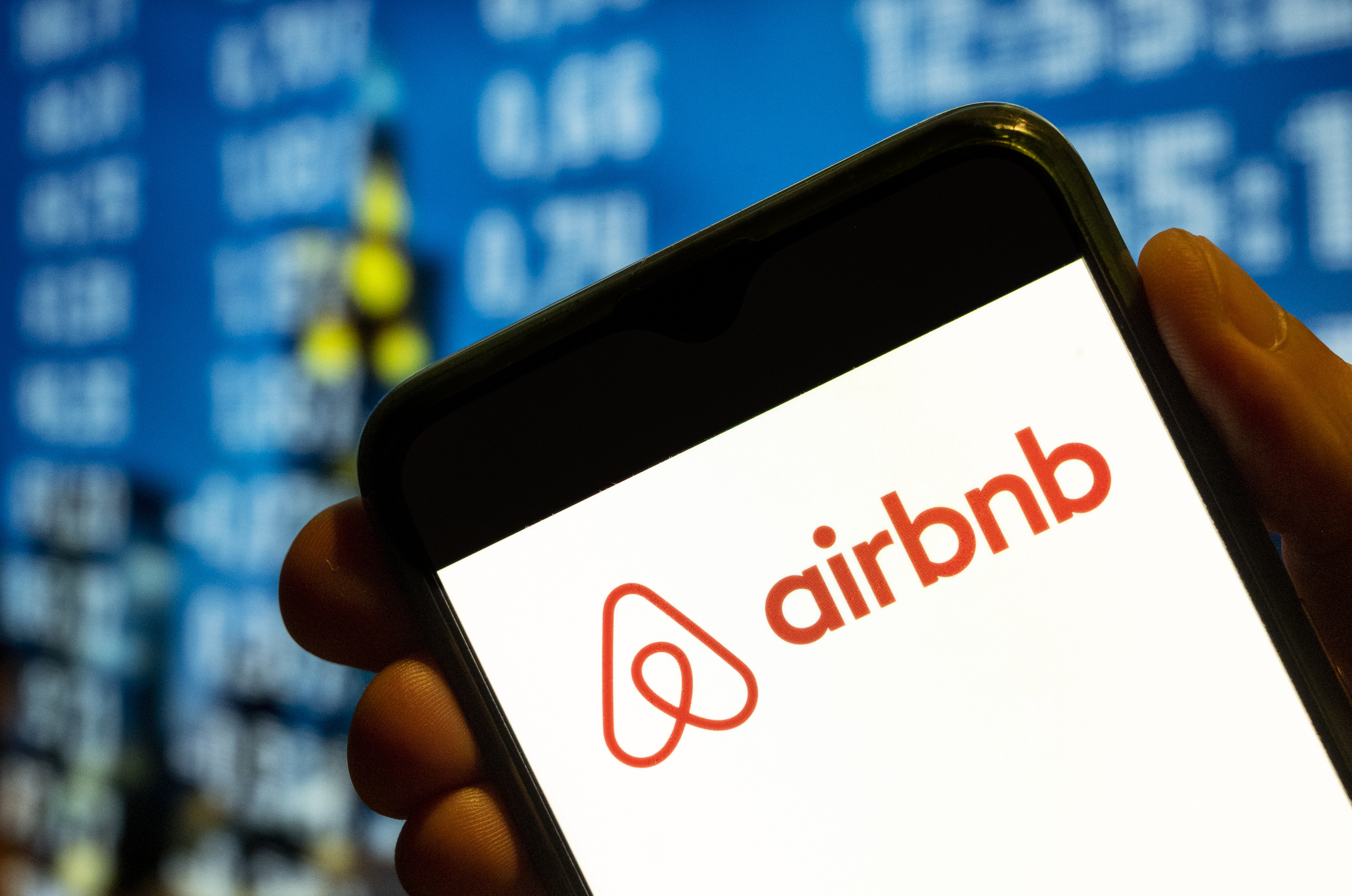 Airbnb logo on a smartphone screen