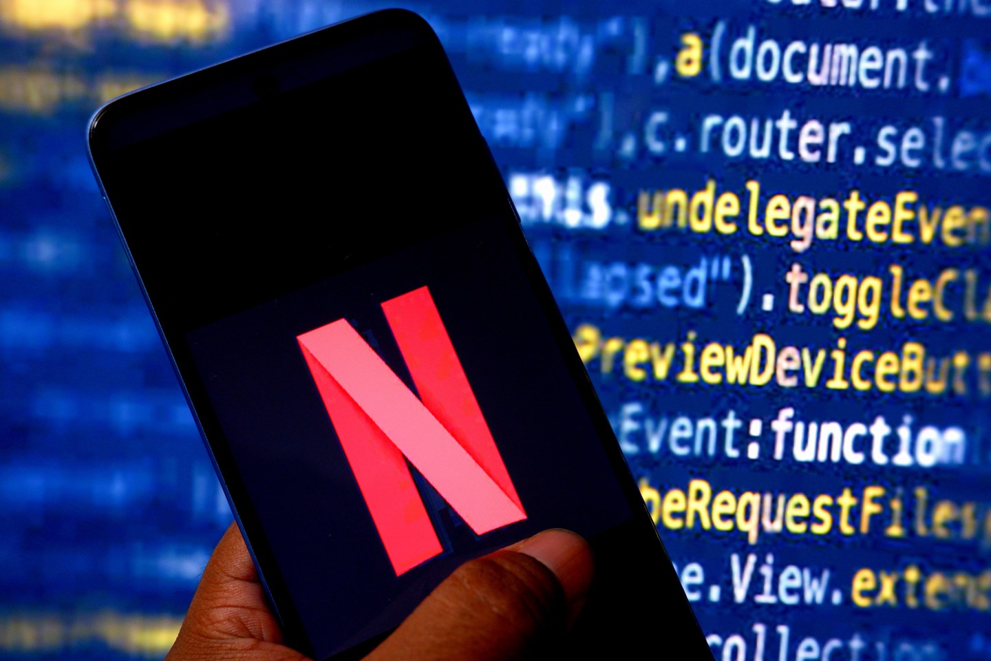 A Netflix logo appears on a smartphone