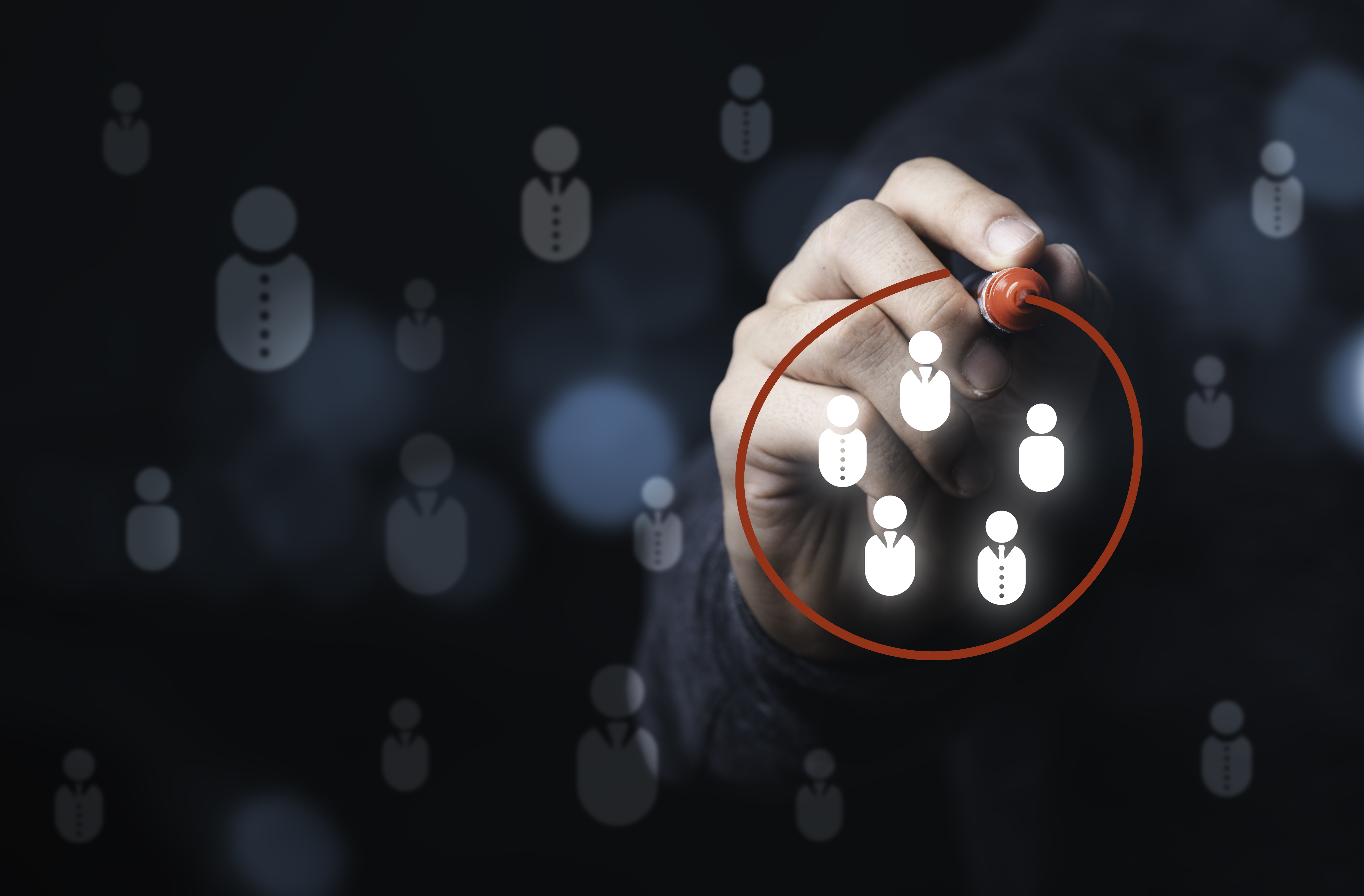 Businessman drawing red circle to marking and select human icons