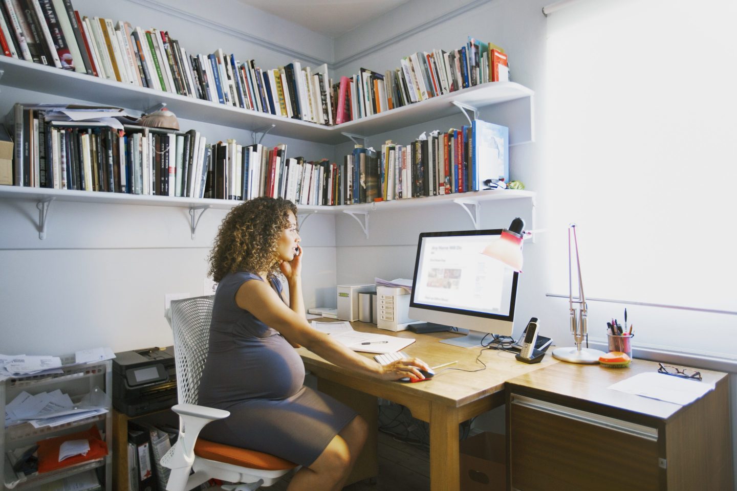 Pregnant lady works from her home office