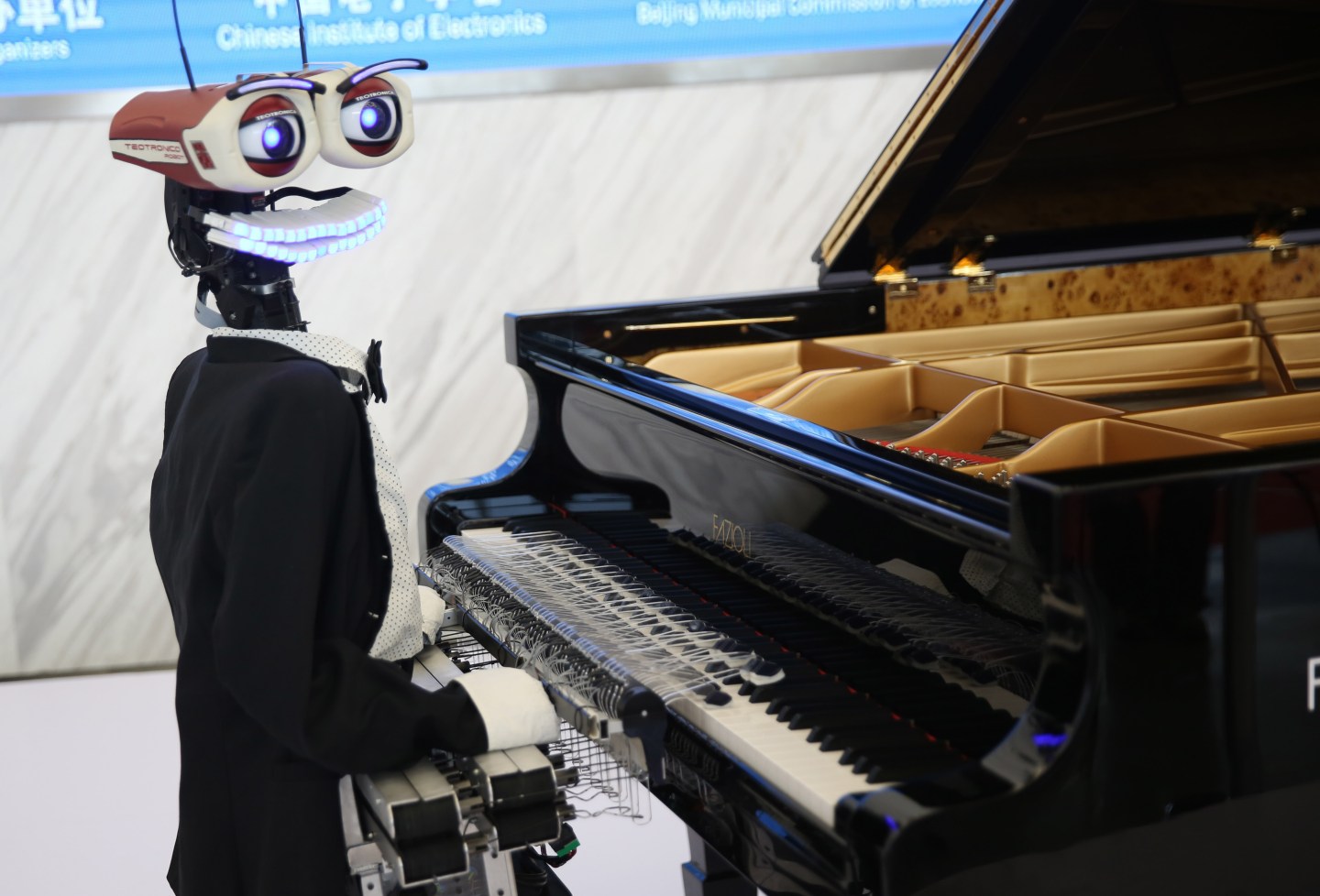 A robot pianist performs at the World Robot Conference