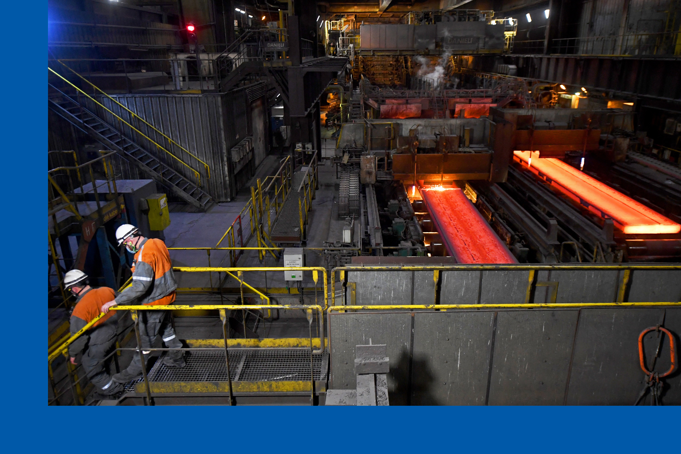Employees are seen at the ArcelorMittal steel works at their Dunkirk site, northern France on February 11, 2022. 