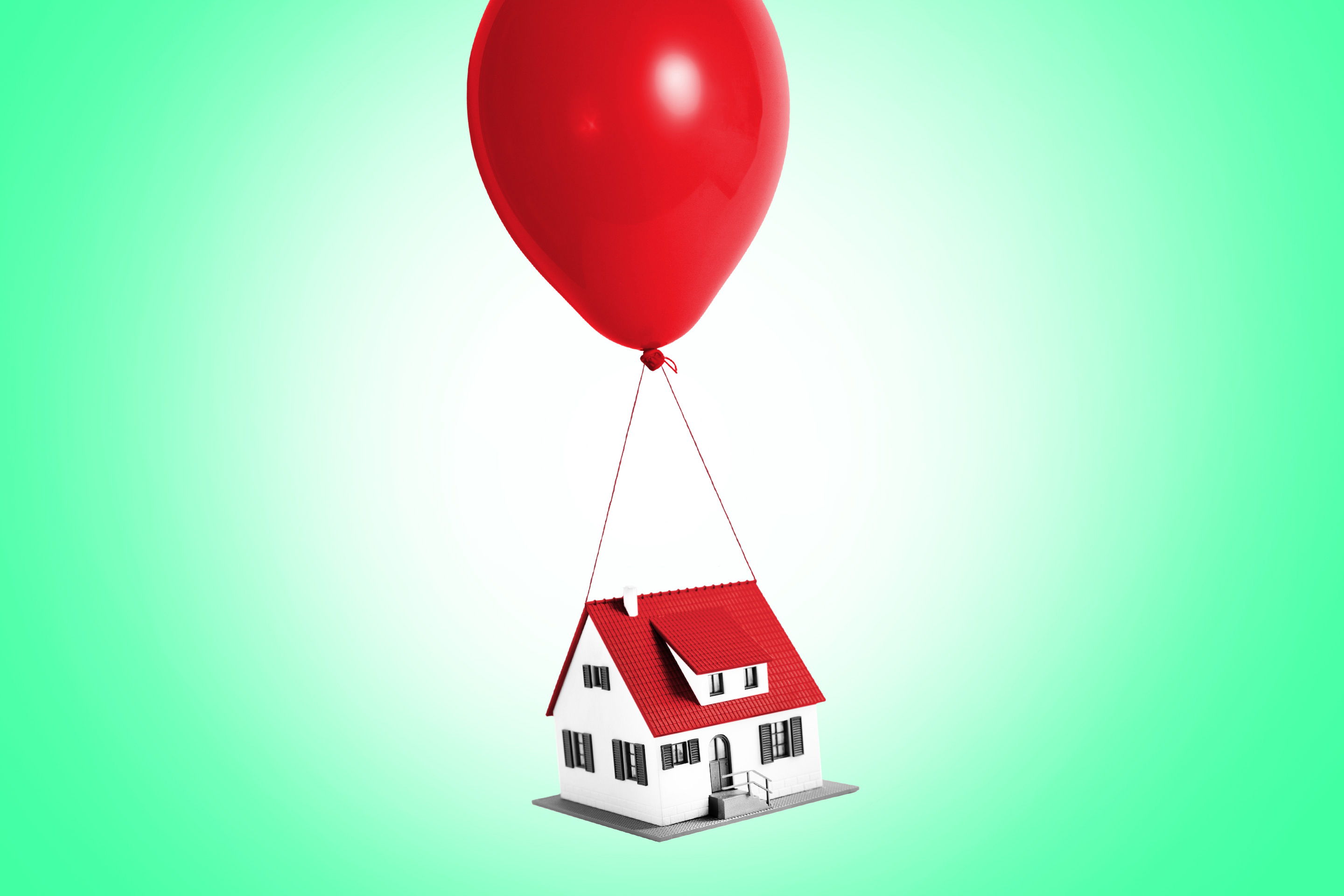 A home floats away with the aid of a bright red balloon