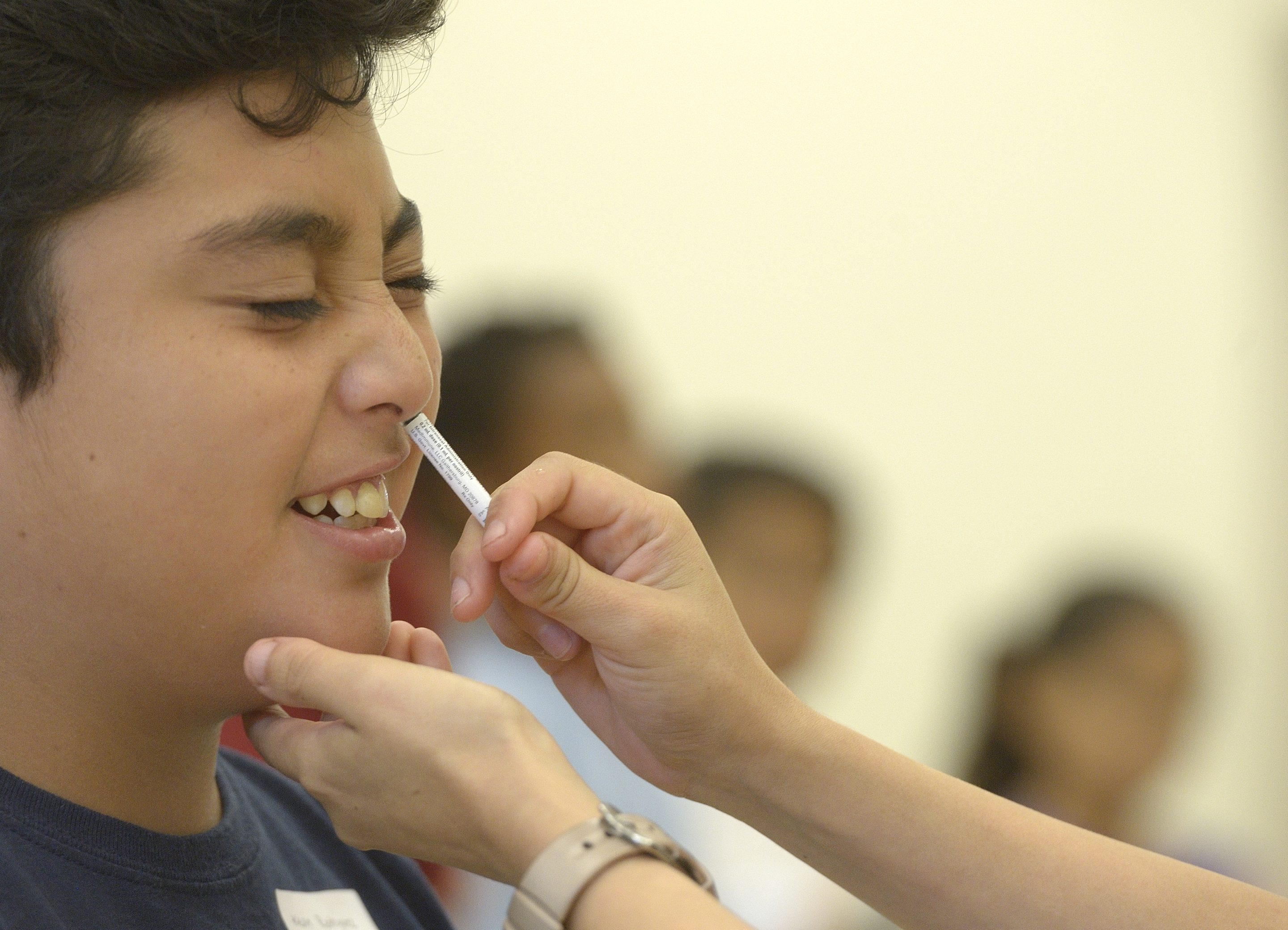 A student receives a FluMist influenza vaccine at Lincoln Elementary in Anaheim, Calif., October 2015.