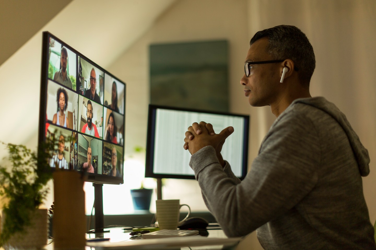 Man working from home speaks to colleagues on a video call