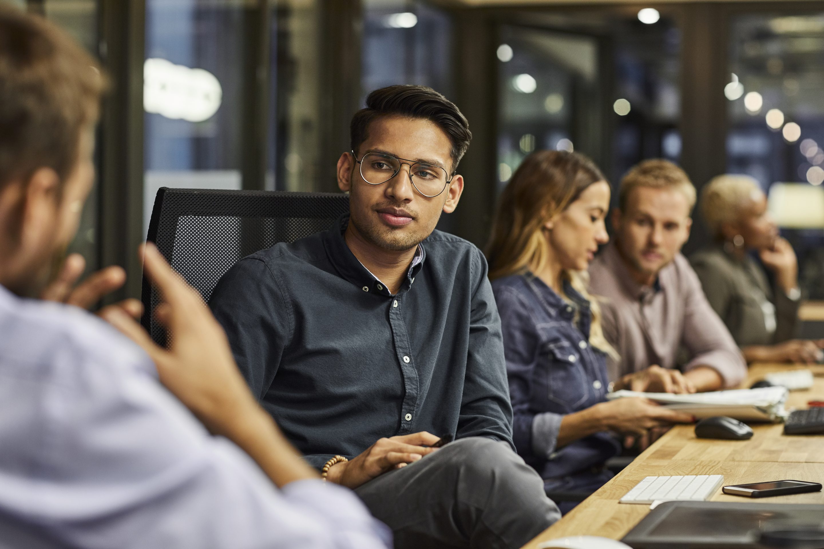 Male and female professionals are working in creative office.