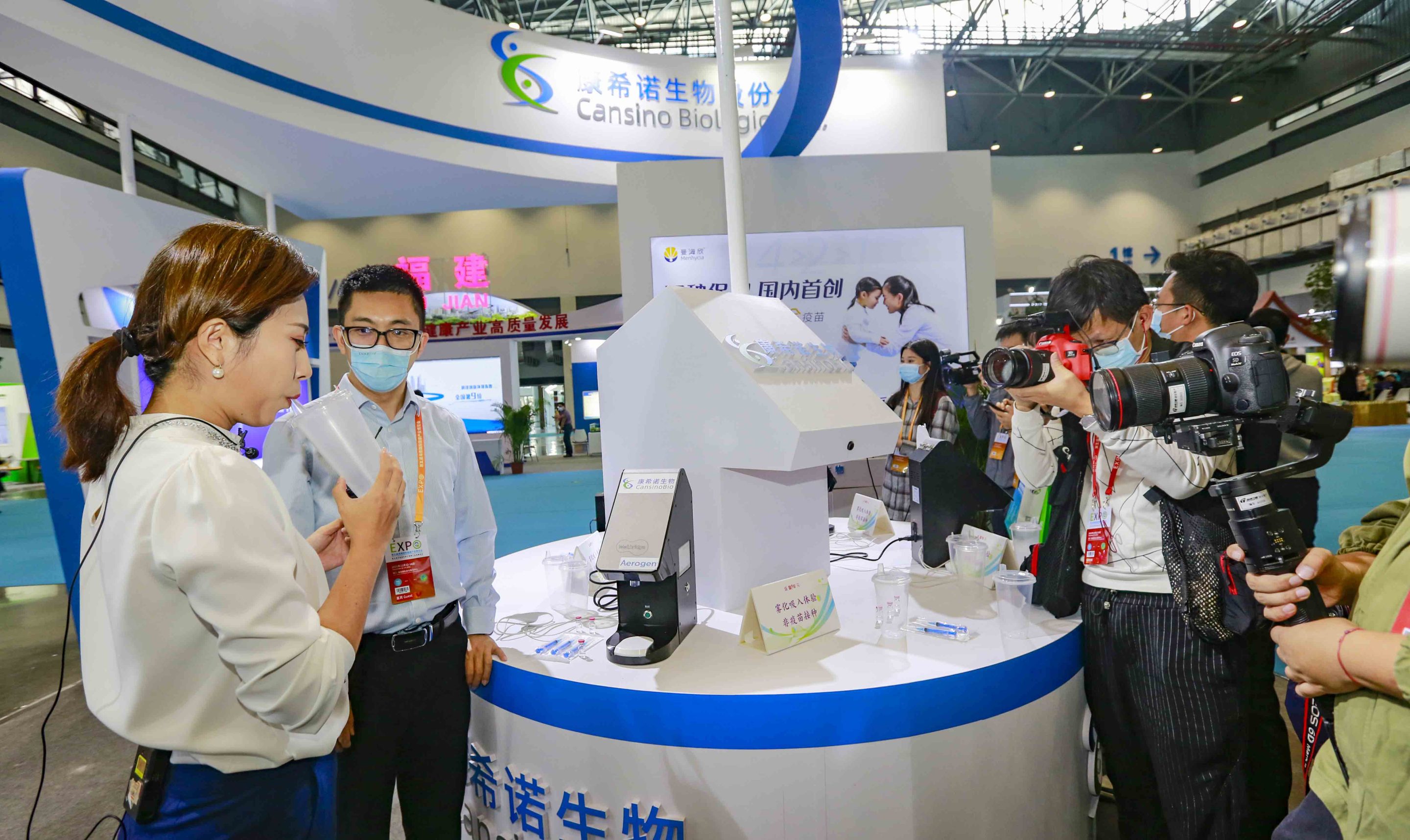 Simulating the vaccination process for an inhaled COVID-19 vaccine at the CanSino Biologics booth during the Fifth Hainan International Health Industry Expo on Nov. 12, 2021, in Haikou, China.