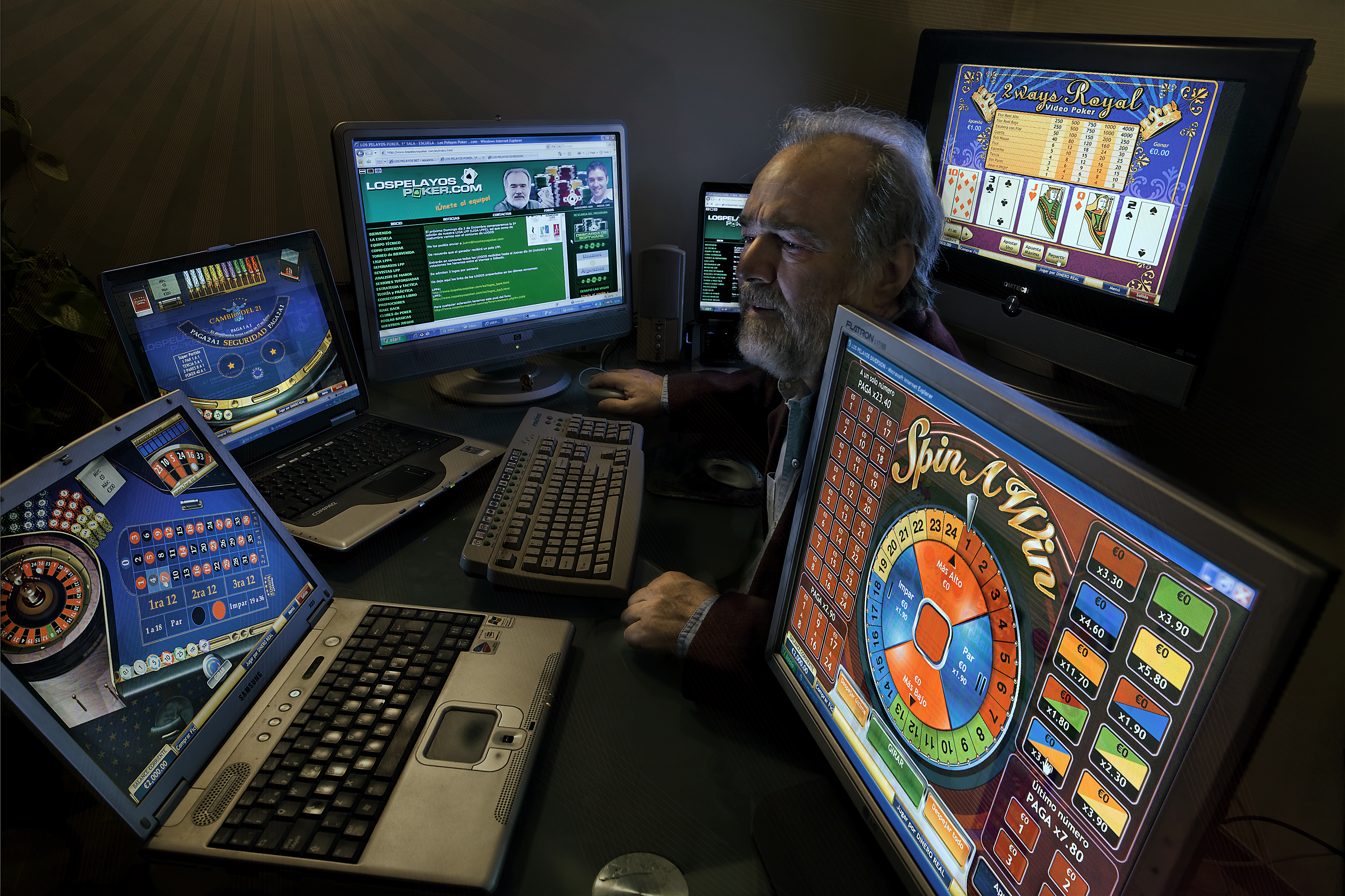 A man surrounded by computers with gambling programs