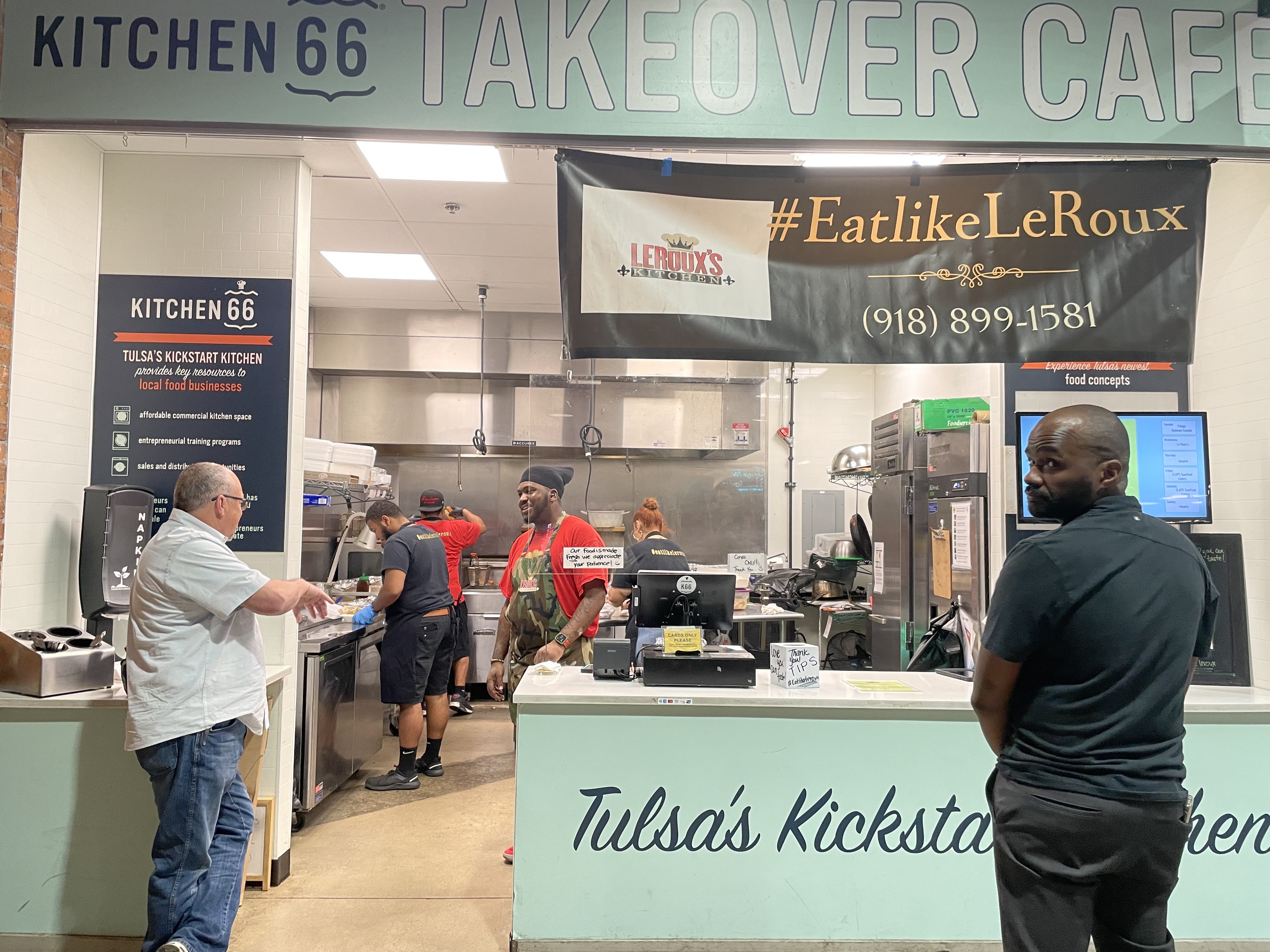 Renauld Porter, a graduate of the Kitchen 66 incubator, chats with a customer outside his Creole-style food popup in Mother Road Market.
