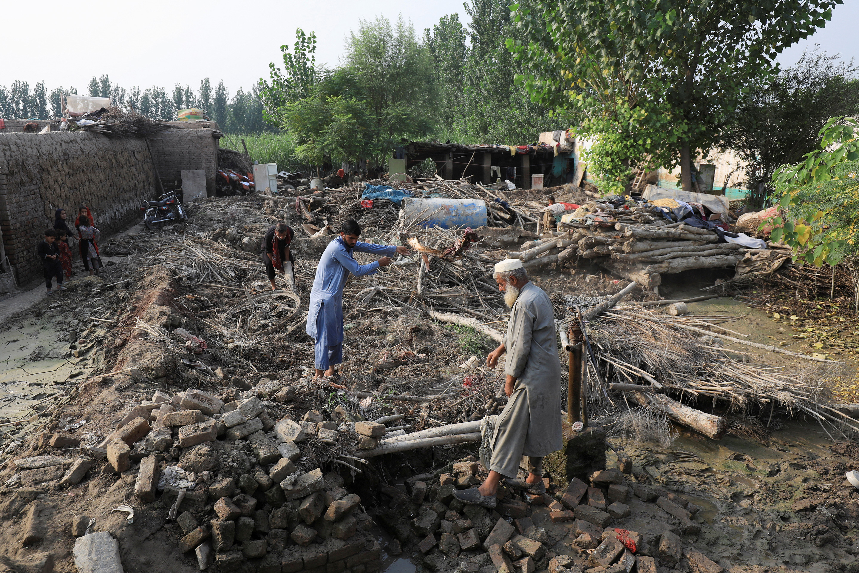 Flood victims clear the rubble of their damaged house, following rains and floods in Nowshera, Pakistan, on Sept. 4, 2022.