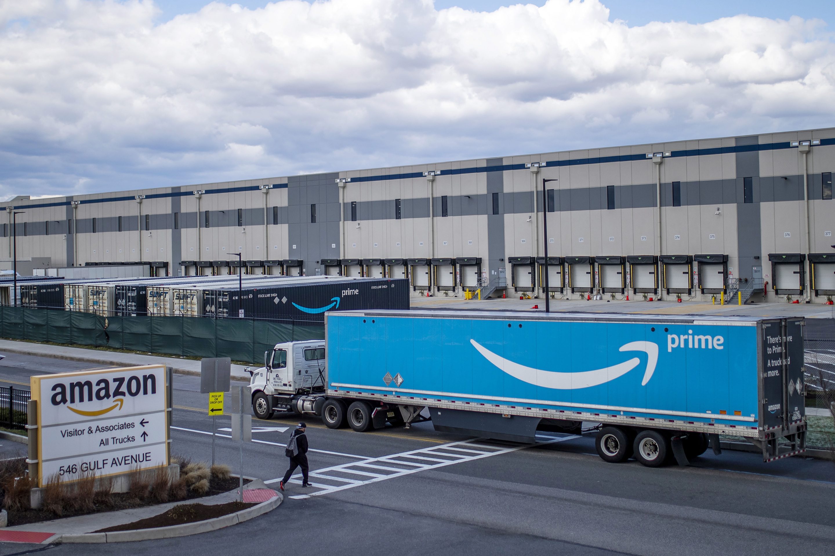 Photo of a truck in front of an Amazon facility