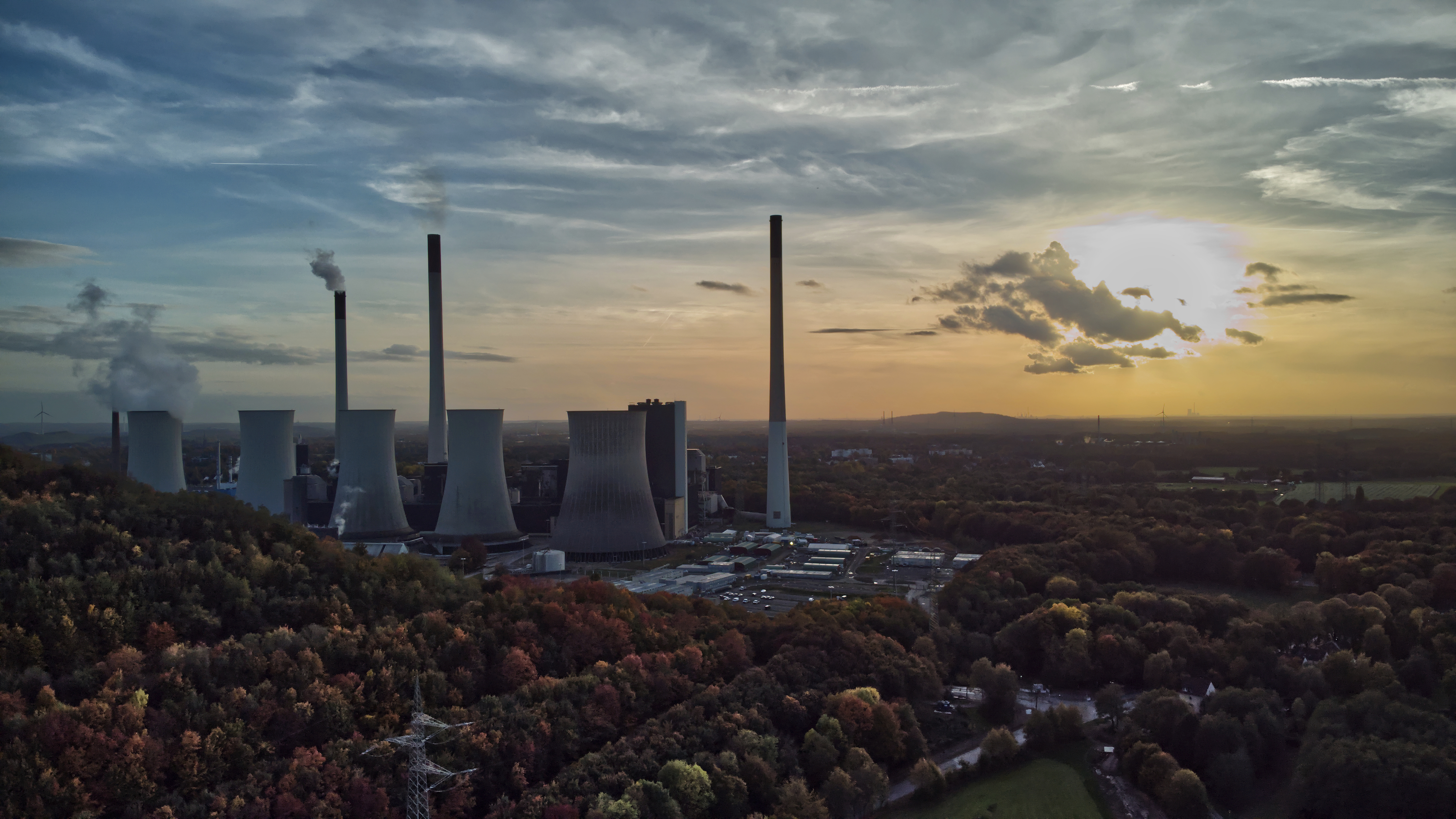 The sun sets behind a coal-fired power plant in Gelsenkirchen, Germany, Oct. 22, 2022. A new report from doctors and other health experts says the world's fossil fuel addiction is making the world sicker and is killing people. 