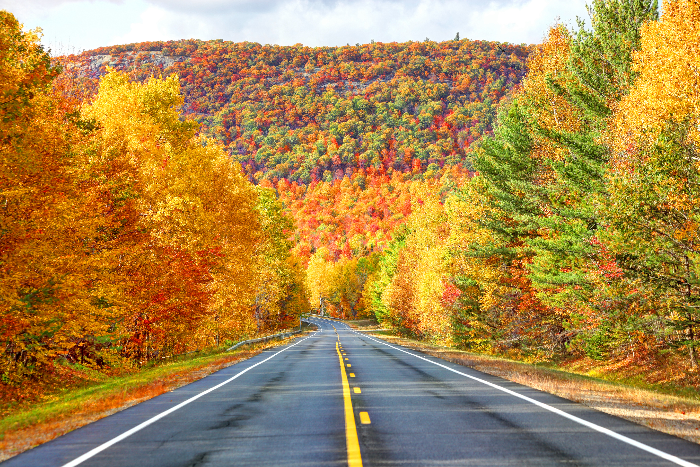 A scenic autumn road in the Adirondacks region of New York.