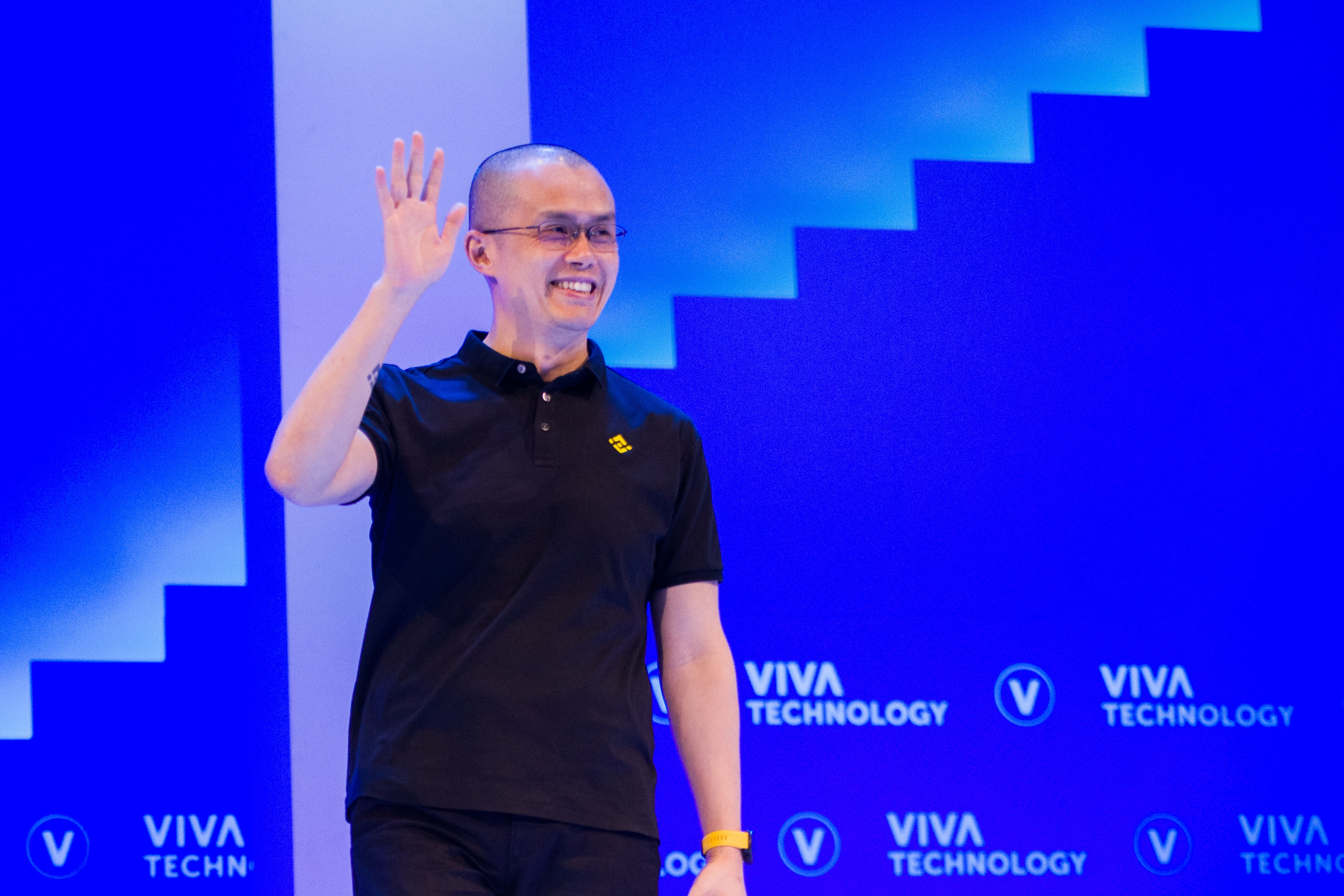 Changpeng Zhao, founder and chief executive officer of Binance, waves as he arrives on stage for a panel session on the second day at the Vivatech Conference in Paris on June 16, 2022.
