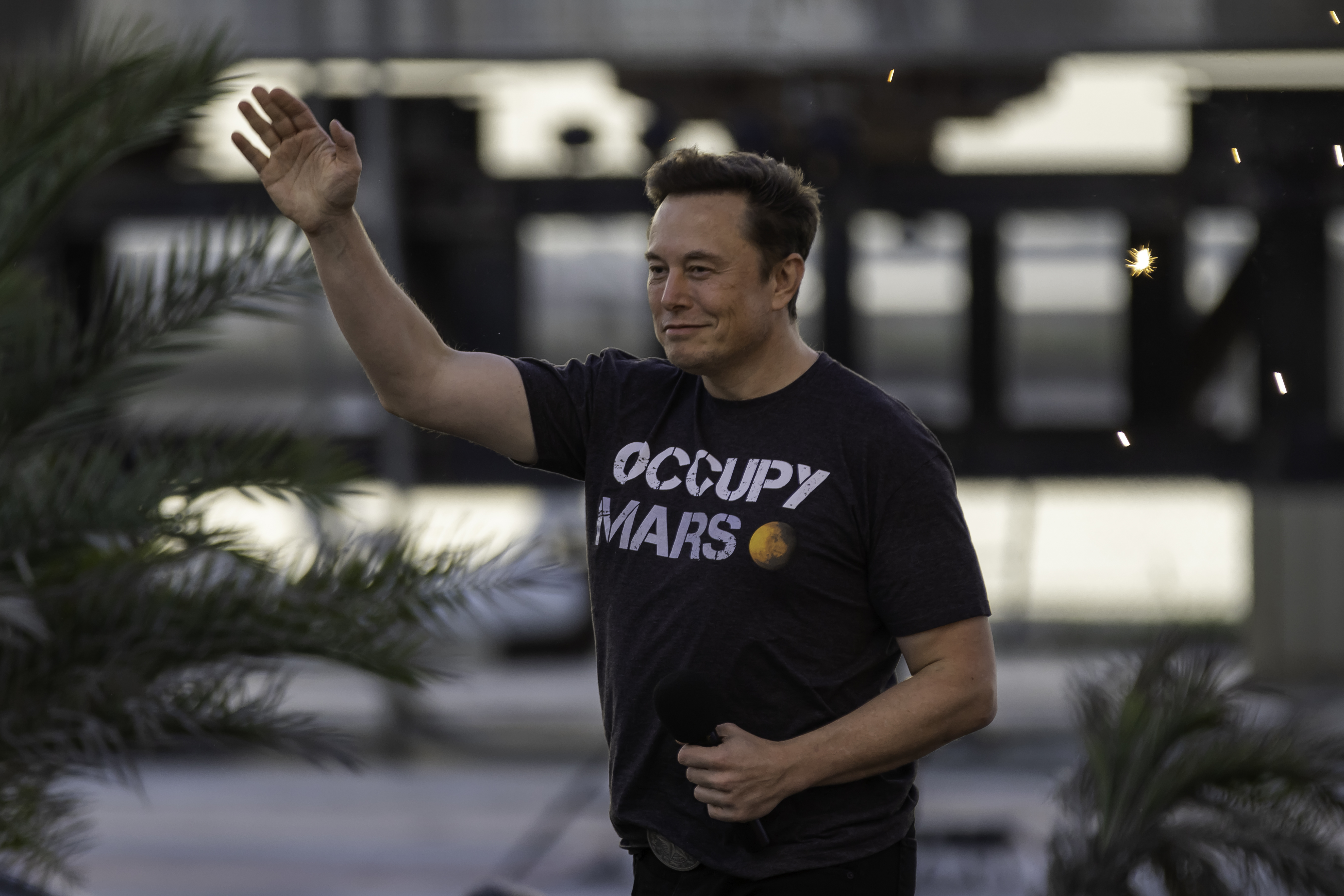 Shot of Elon Musk waving to a crowd at a SpaceX event