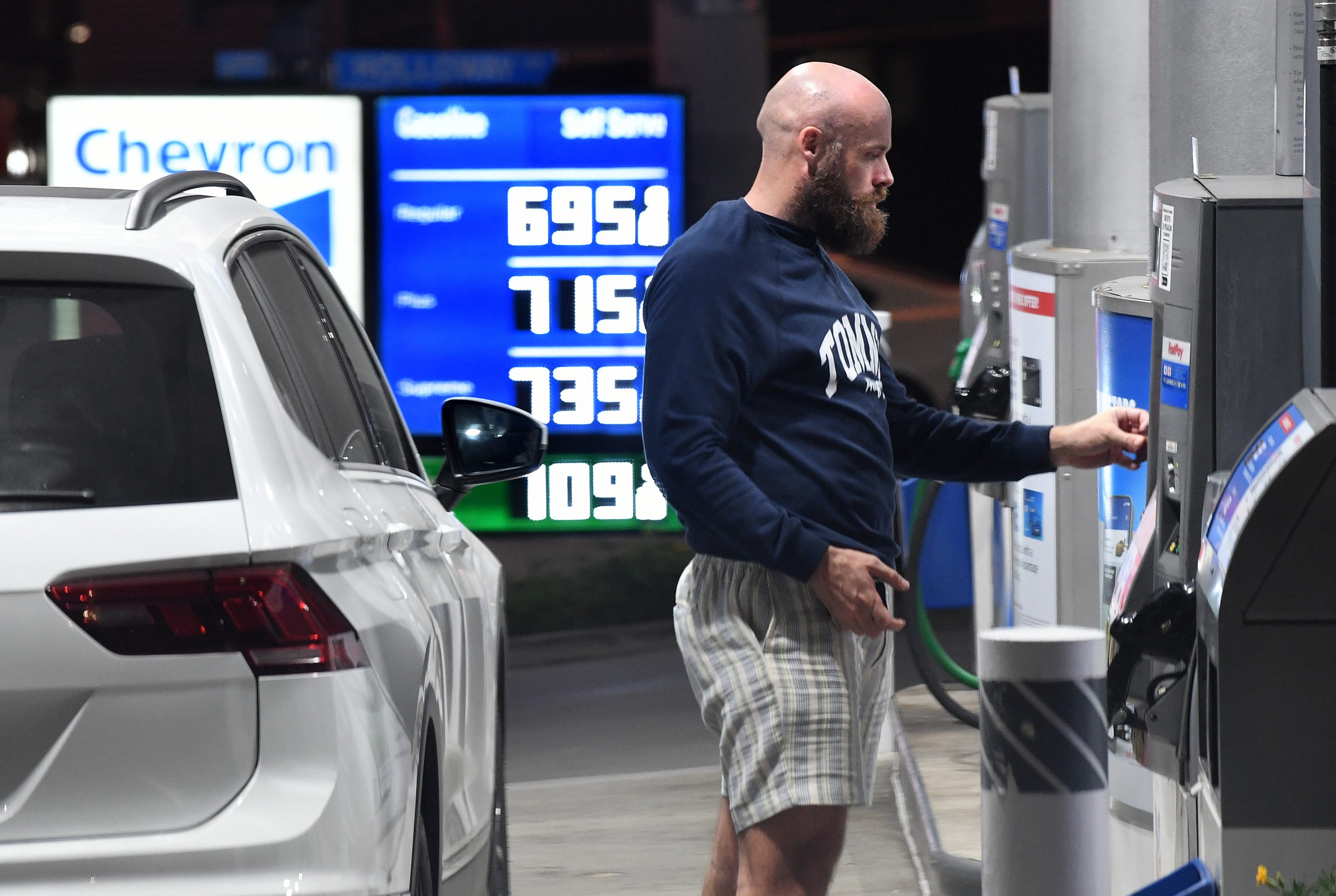 A customer pays at the pump at a Chevron station in West Hollywood on Oct. 7.