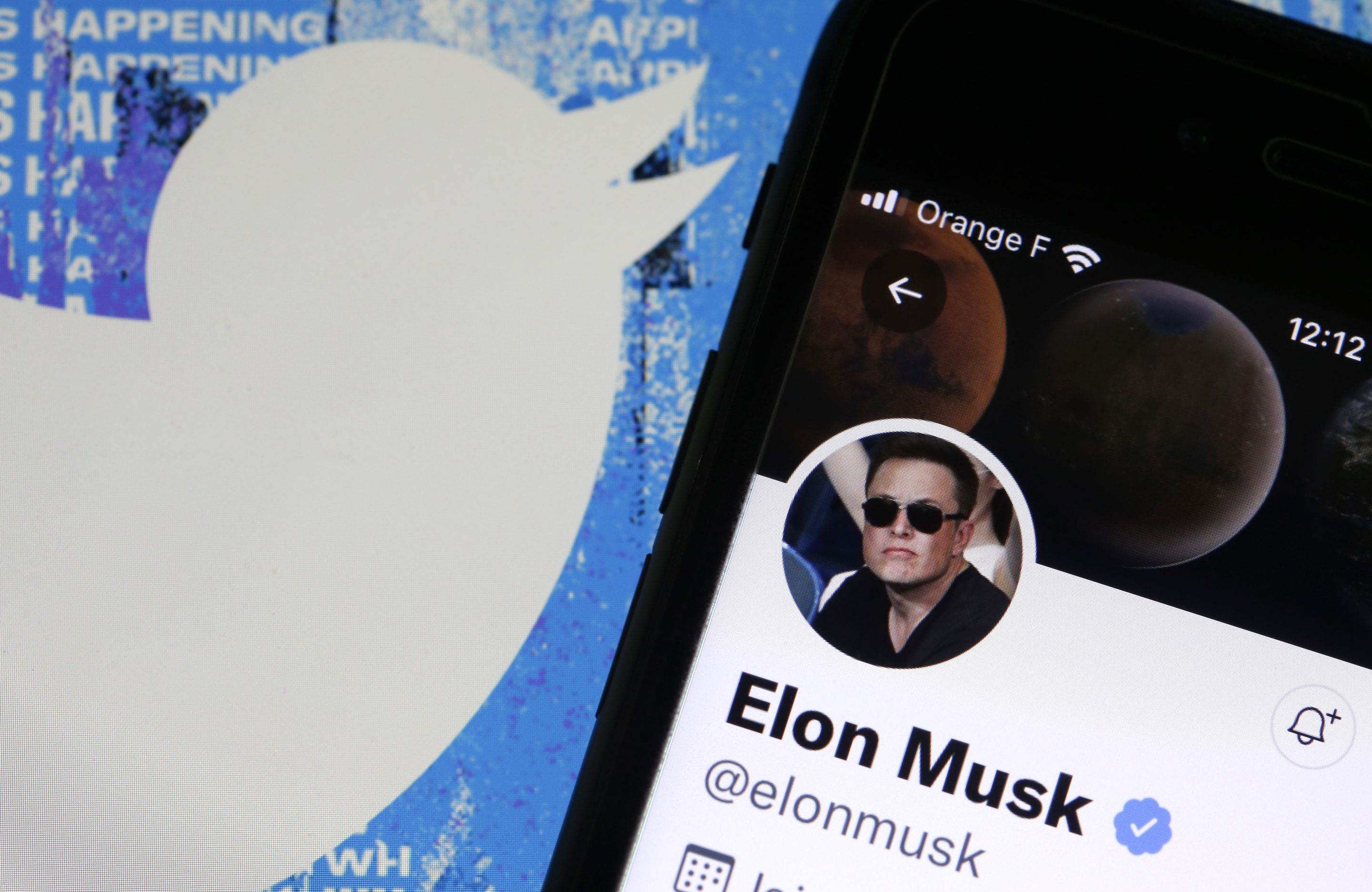 Elon Musk’s Twitter account is displayed on the screen of an iPhone