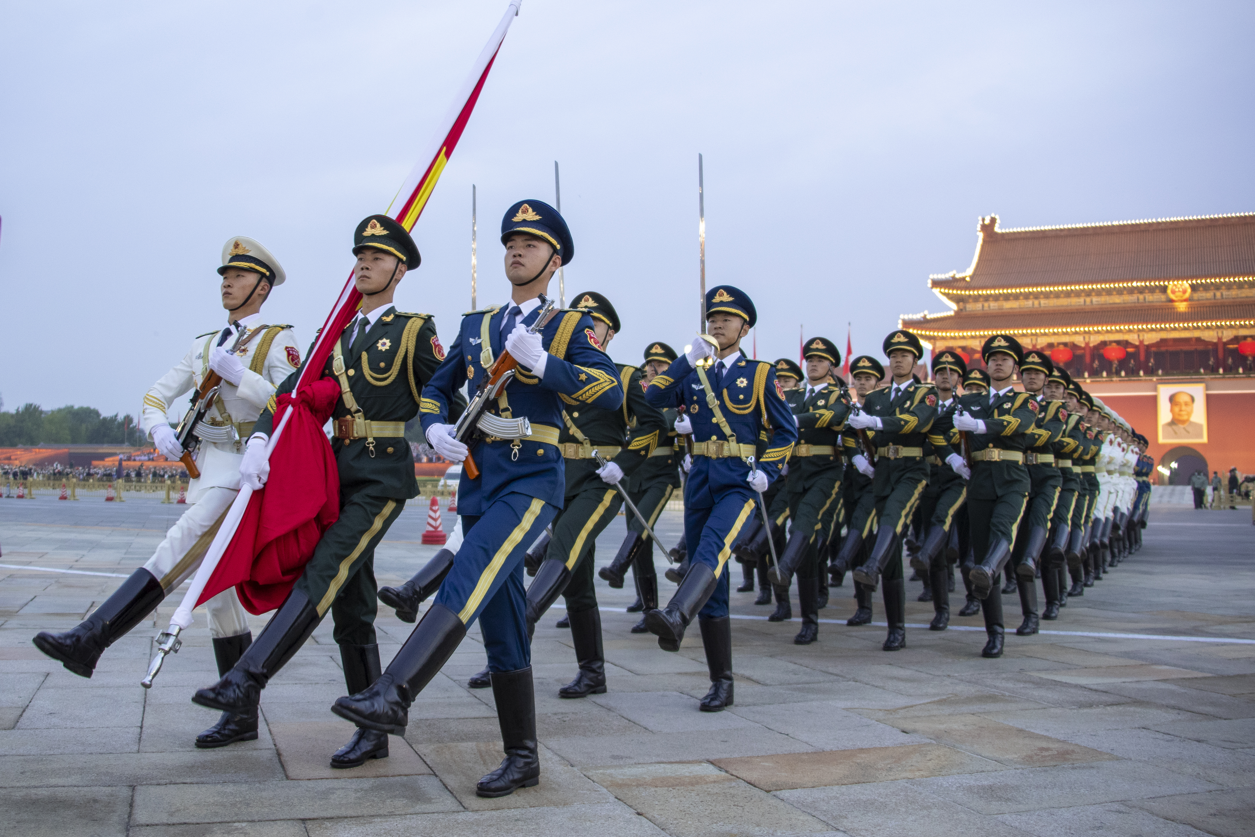 The Guard of Honor of the Chinese People's Liberation Army escorts the Chinese national flag during a flag-raising ceremony in celebration of the 73rd anniversary of of the founding of the People's Republic of China at Tian'anmen Square on October 1, 2022 in Beijing, China.