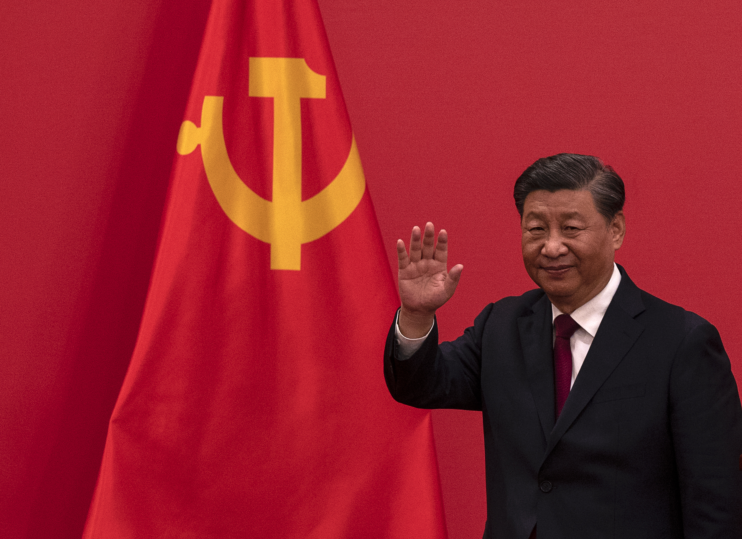 Chinese President Xi Jinping waves as he leaves after speaking at a press event with Members of the new Standing Committee of the Political Bureau of the Communist Party of China and Chinese and Foreign journalists at The Great Hall of People on Oct. 23, 2022 in Beijing.