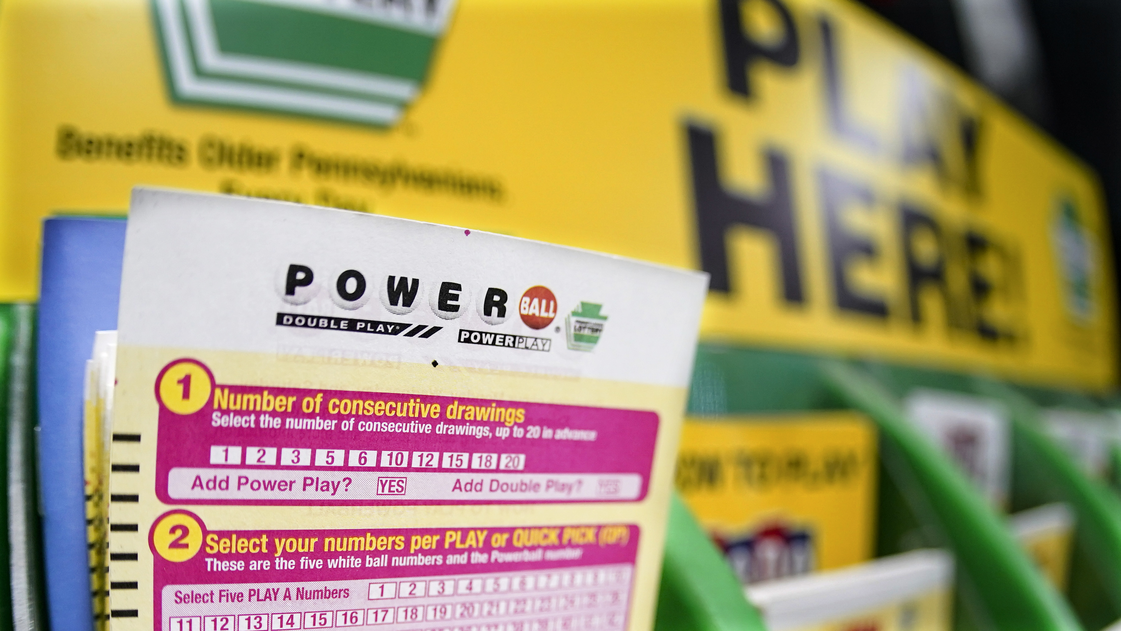 A rack with cards bettors can use to choose their own numbers to purchase lottery tickets for the Saturday Oct. 29, drawing of the Powerball lottery, are seen on a counter at a market in Prospect, Pa., on Oct. 28, 2022.