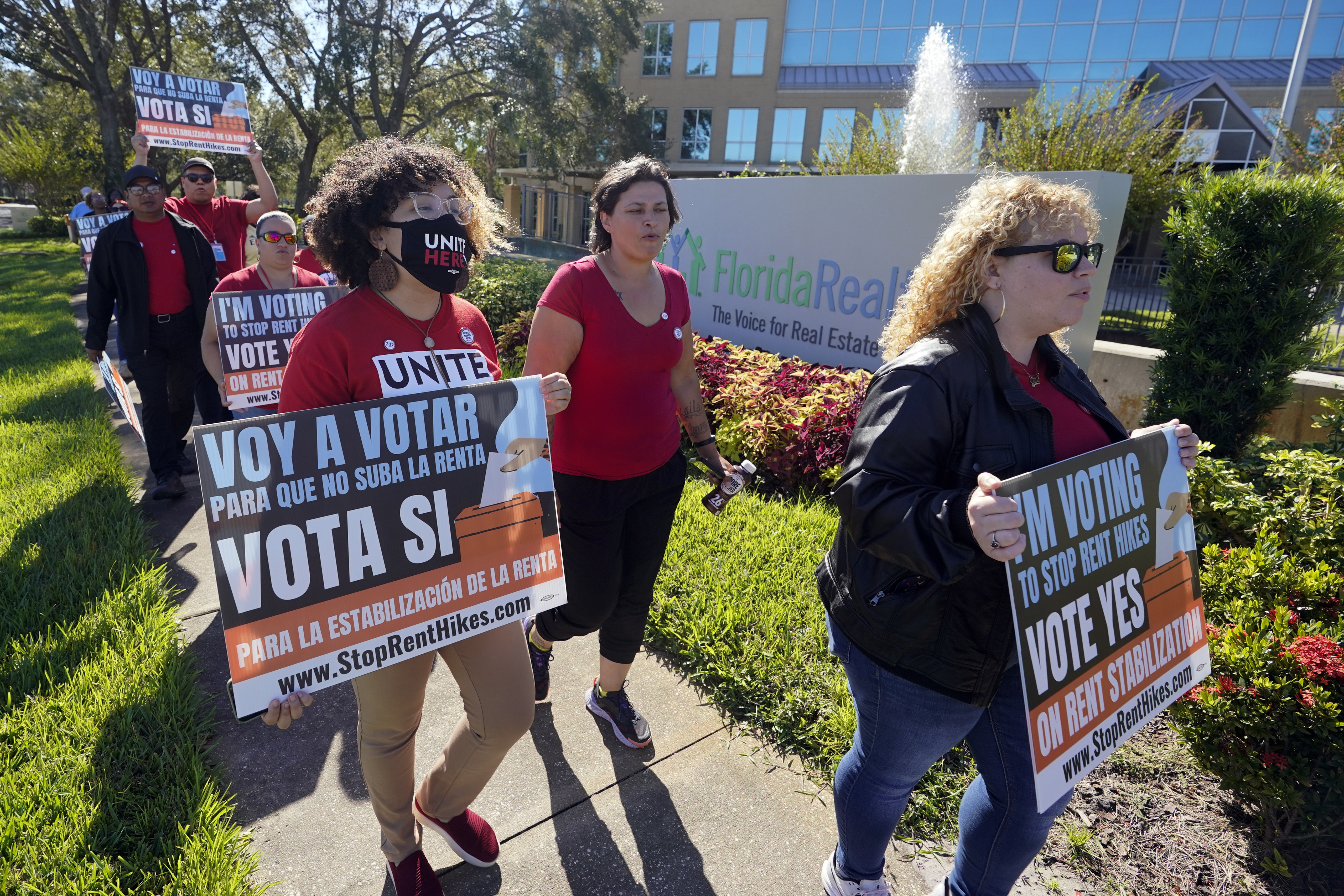 Rent control advocates for Orange County demonstrate in front of the Florida Realtors office building on Oct. 22, 2022, in Orlando, Fla.