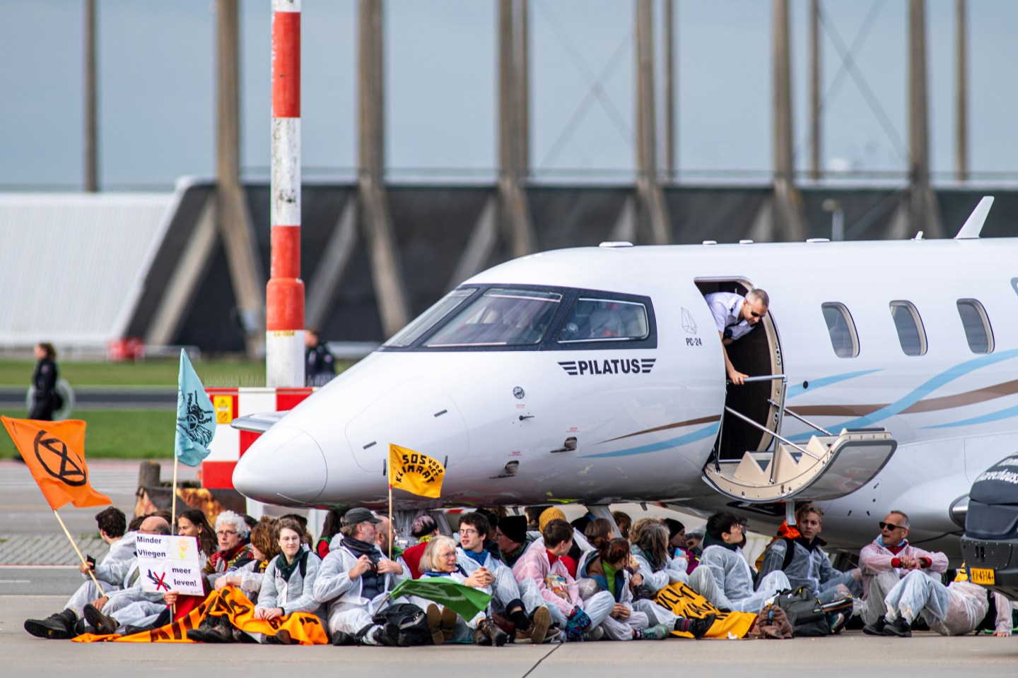 Hundreds of climate activists stormed Amsterdam Schiphol Airport and blocked private jets on the runway