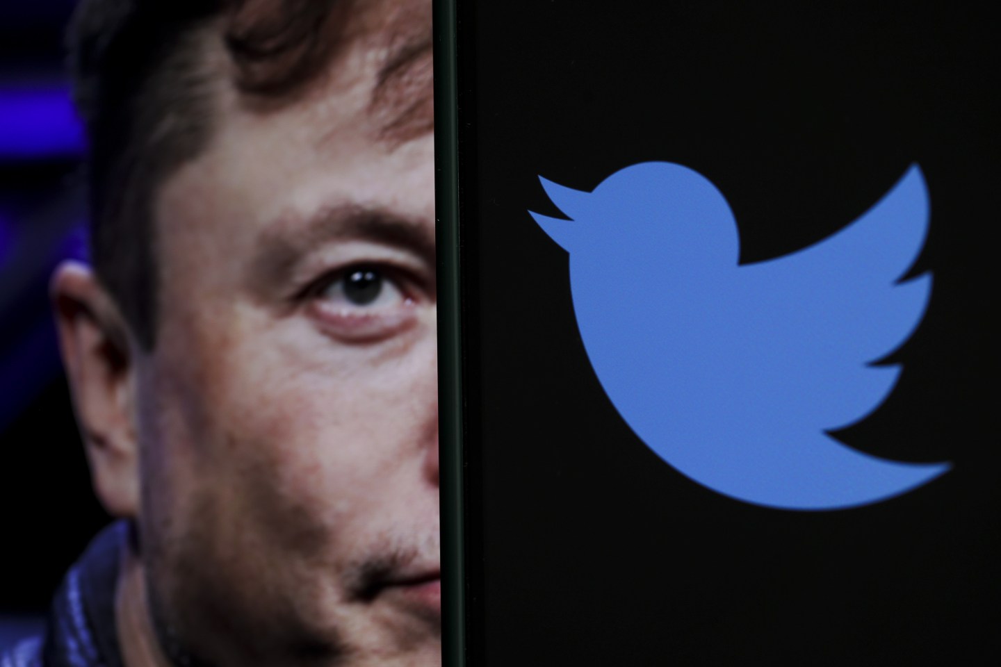 In this photo illustration, the image of Elon Musk is displayed on a computer screen and the logo of twitter on a mobile phone in Ankara, Turkiye on October 06, 2022.
