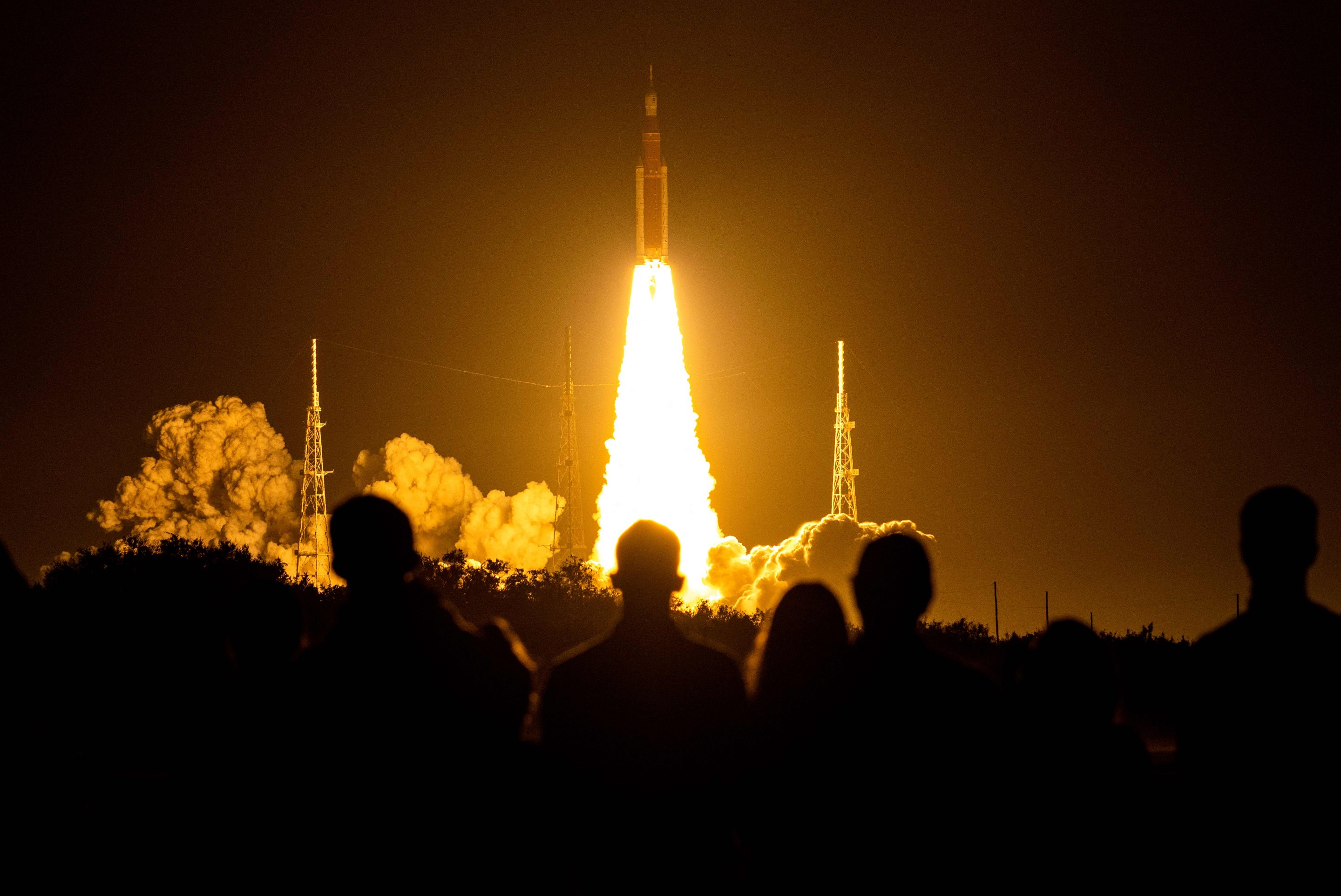 People watch as the Artemis I unmanned lunar rocket lifts off from the launch pad at NASA's Kennedy Space Center in Cape Canaveral, Florida, on Nov. 16.