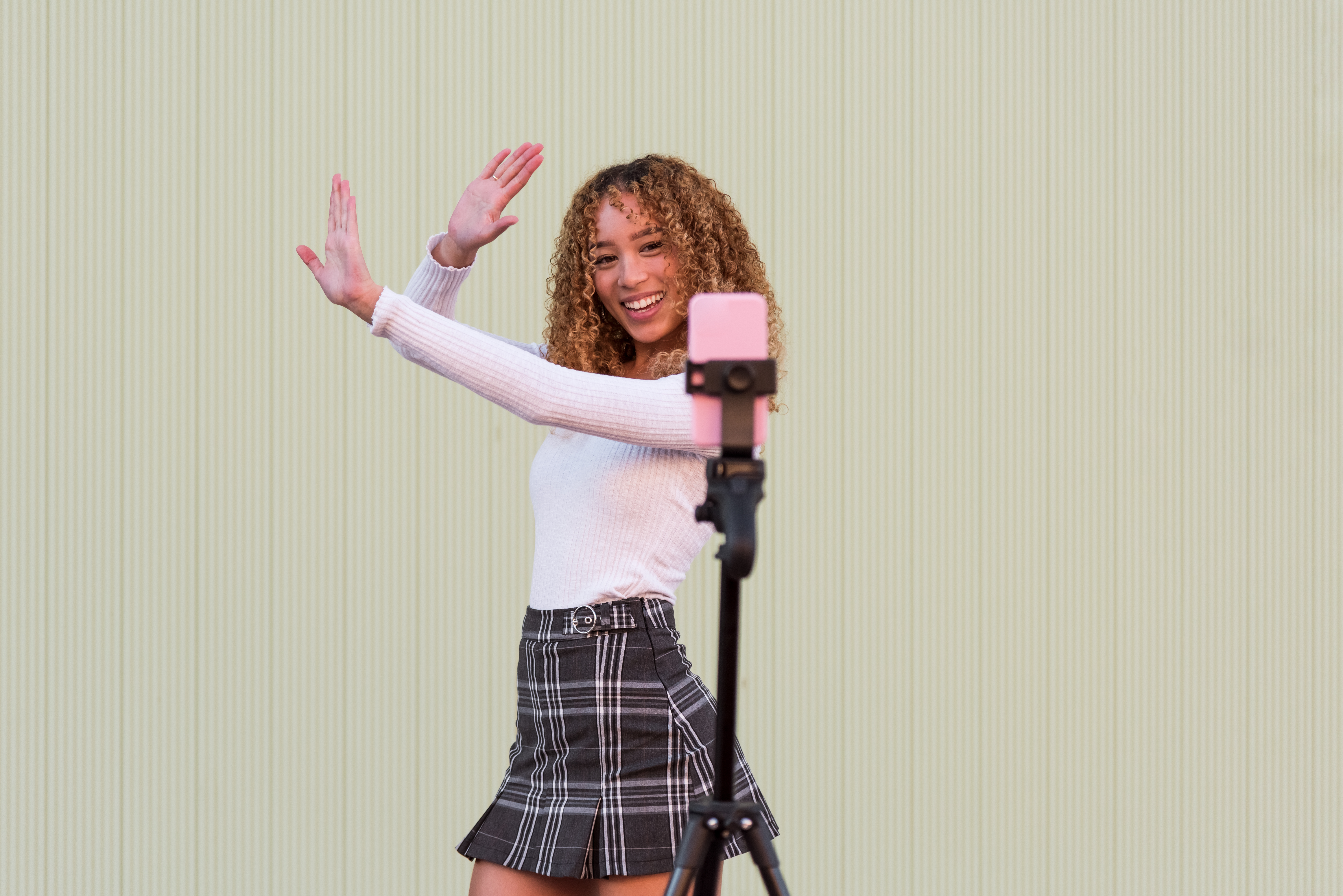 A woman dancing in front of a camera