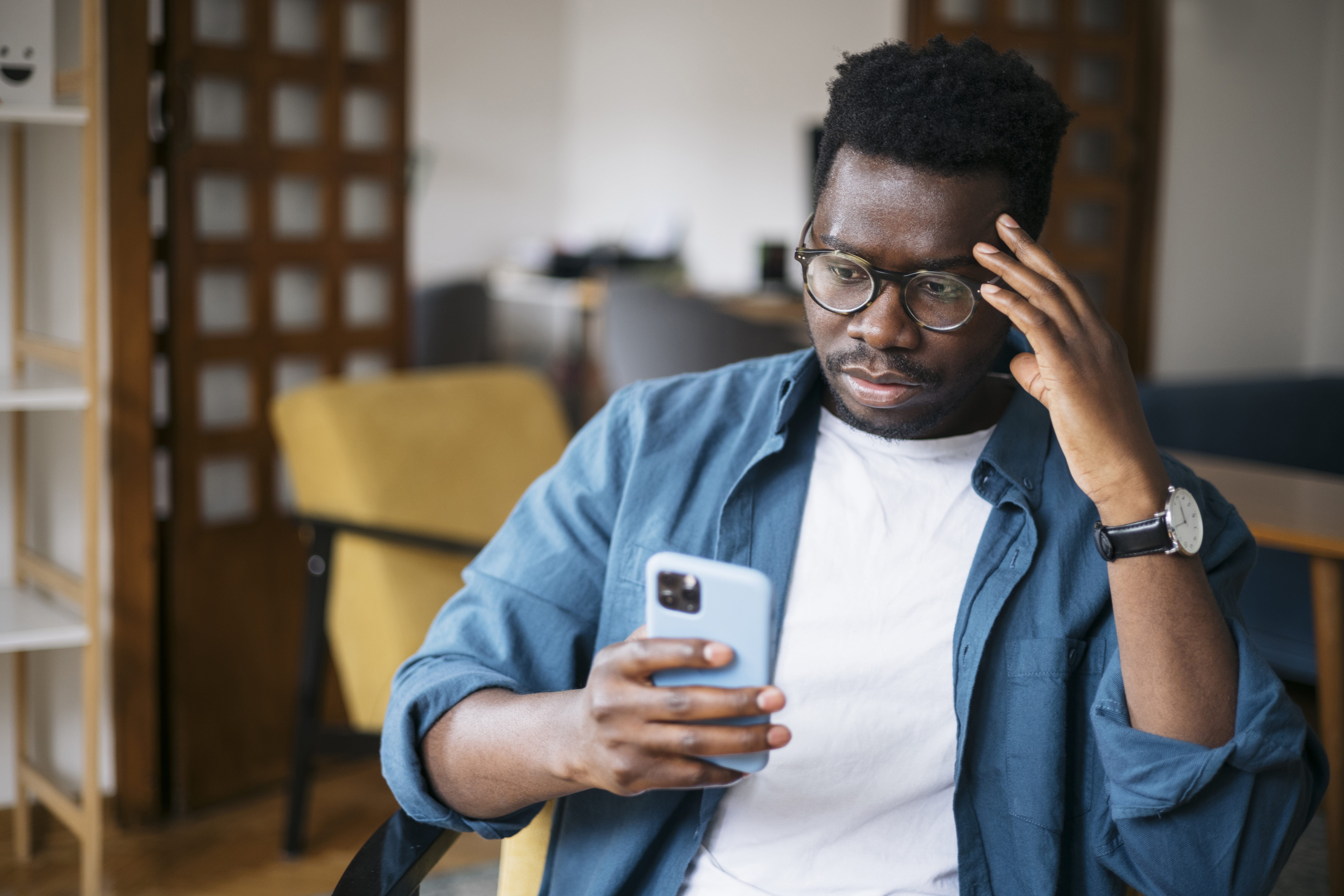 man looks at phone