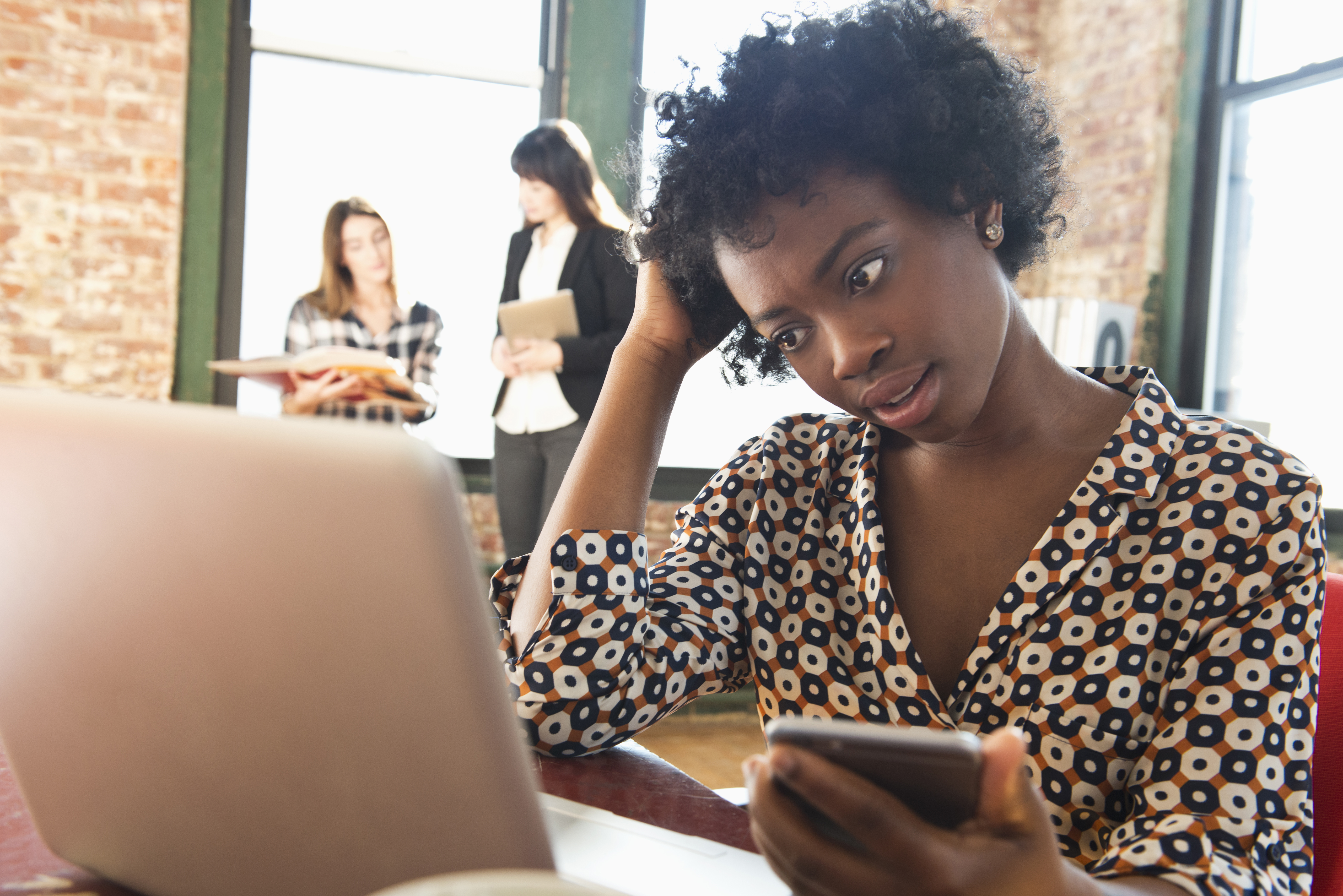 Confused woman looking at laptop