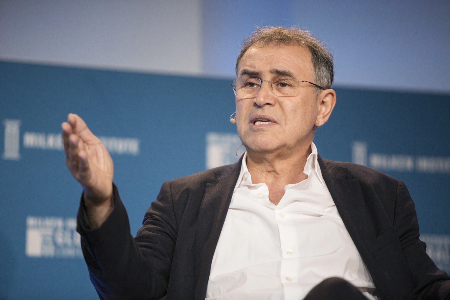 Economist Nouriel Roubini speaking on stage at the 2018 Milken Conference