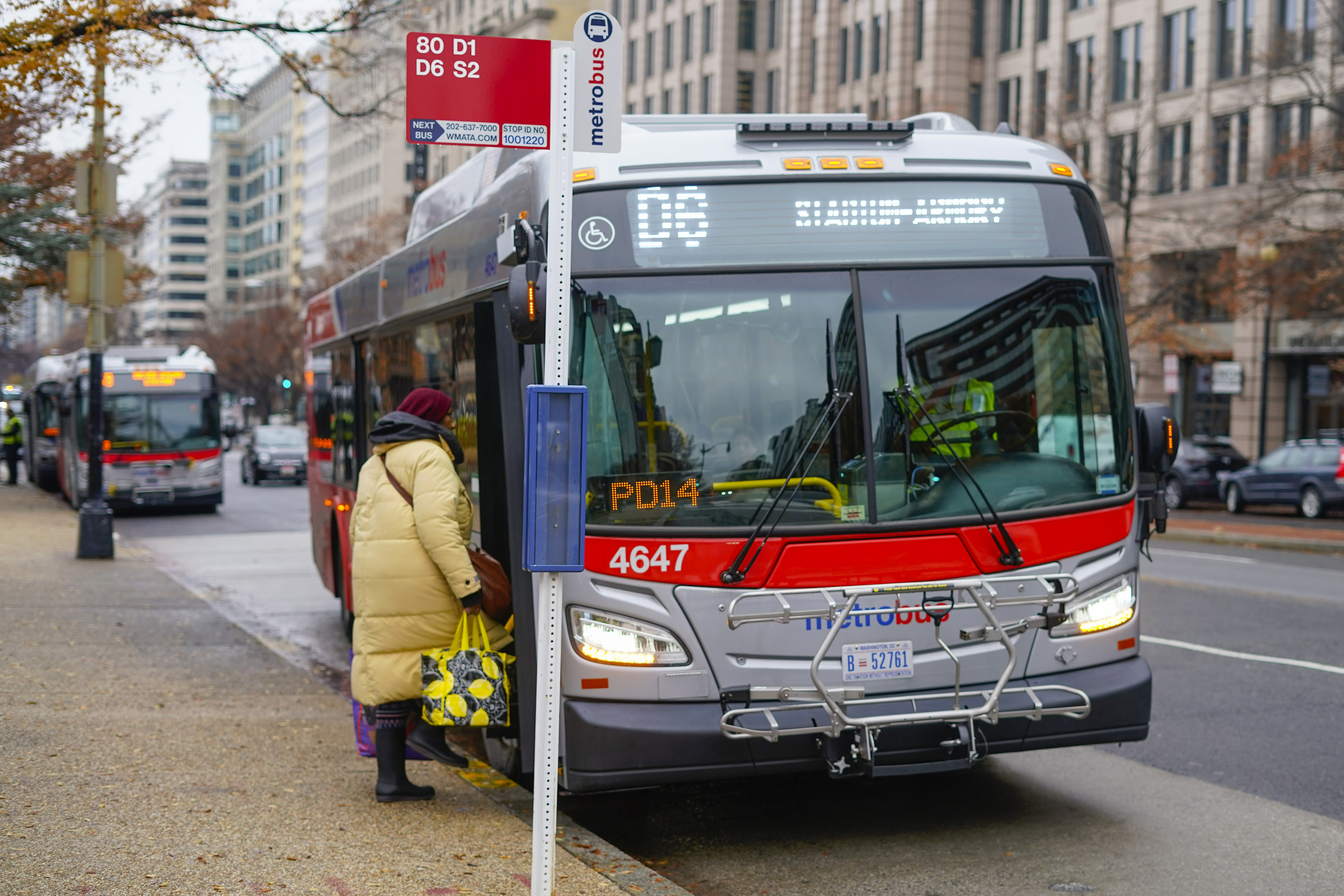 A passenger boards a Metrobus in downtown Washington on Dec. 7, 2022. The Washington D.C. government voted to waive fares for Metrobus rides within city limits starting July, 1, 2023, becoming the nation's most populous city to offer free public transit.