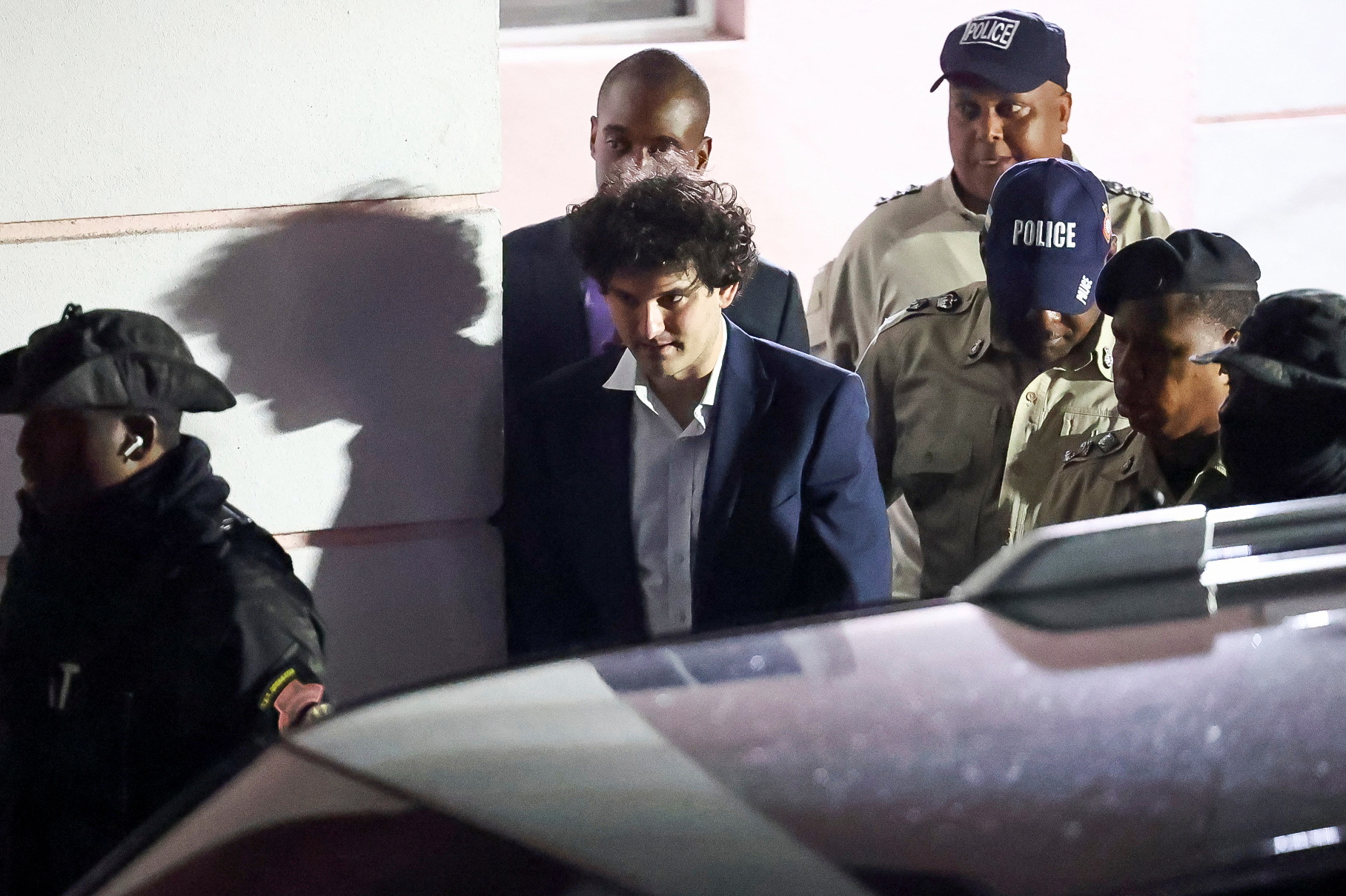 Sam Bankman Fried is escorted out of the Magistrate Court building after his arrest in Nassau, Bahamas December 13, 2022.