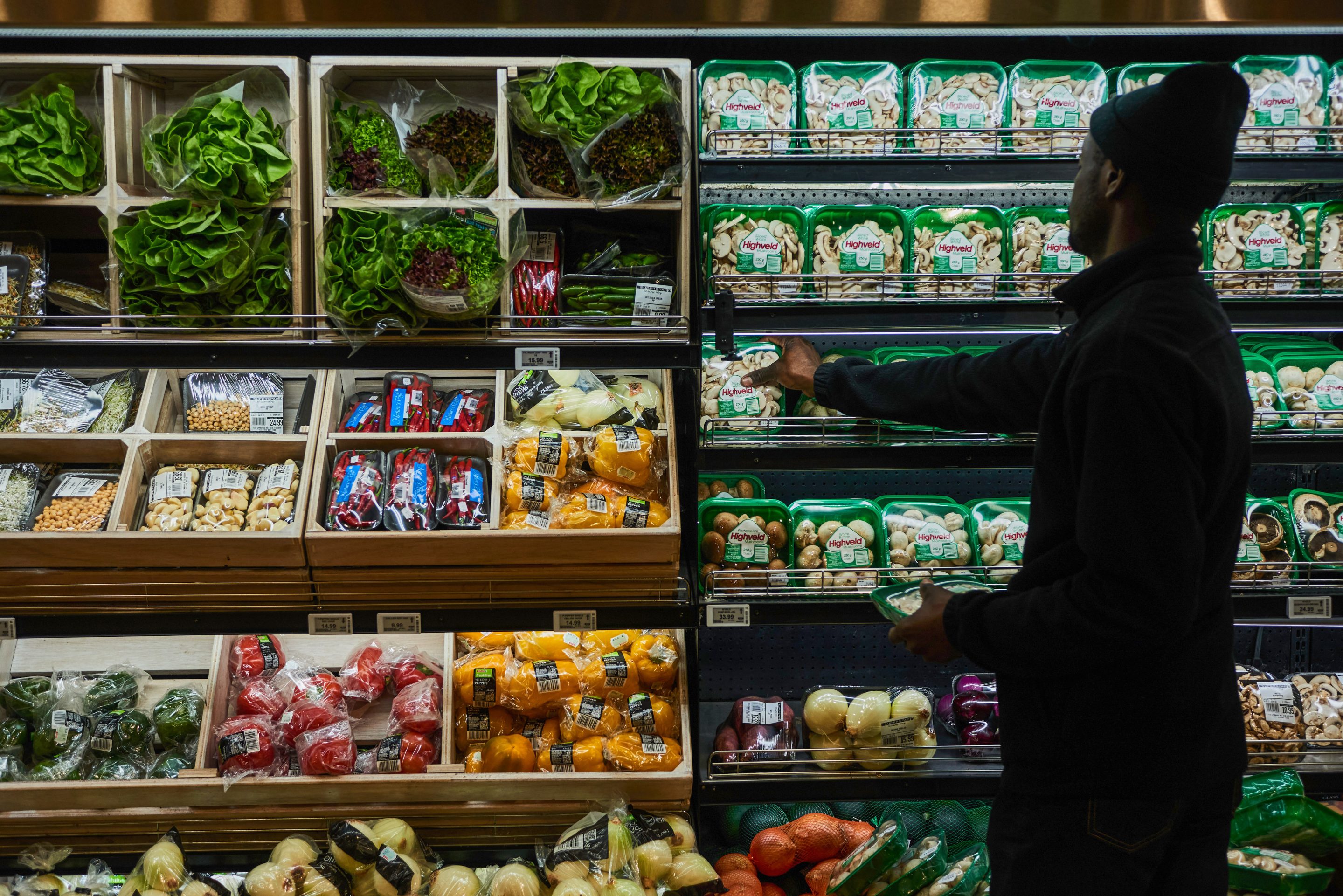 A customer picks packets of mushrooms from the fresh produce aisle inside a Spar Group Ltd. supermarket