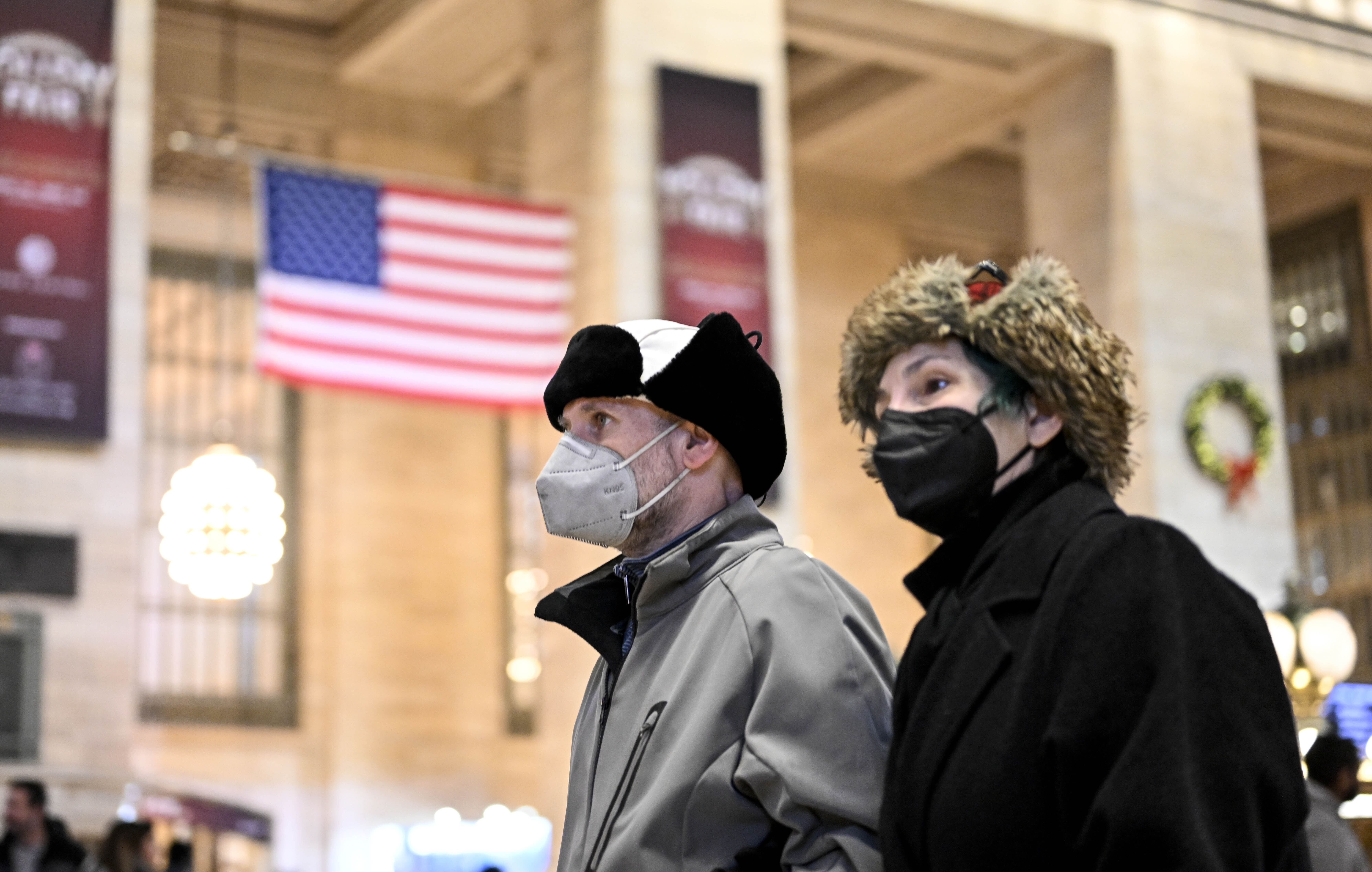 People wear masks in New York City on Dec. 12, 2022, as COVID cases continue to rise. 