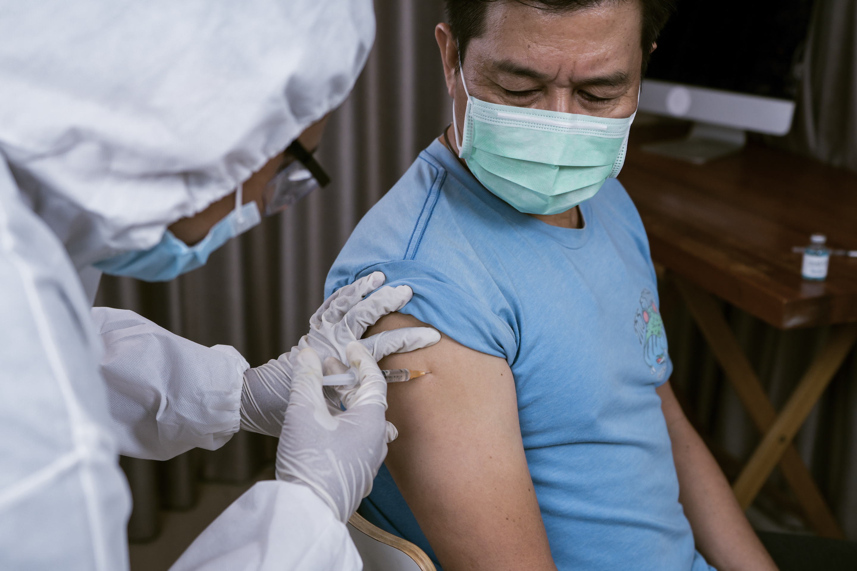 Medical doctor giving injection to make antibody for coronavirus