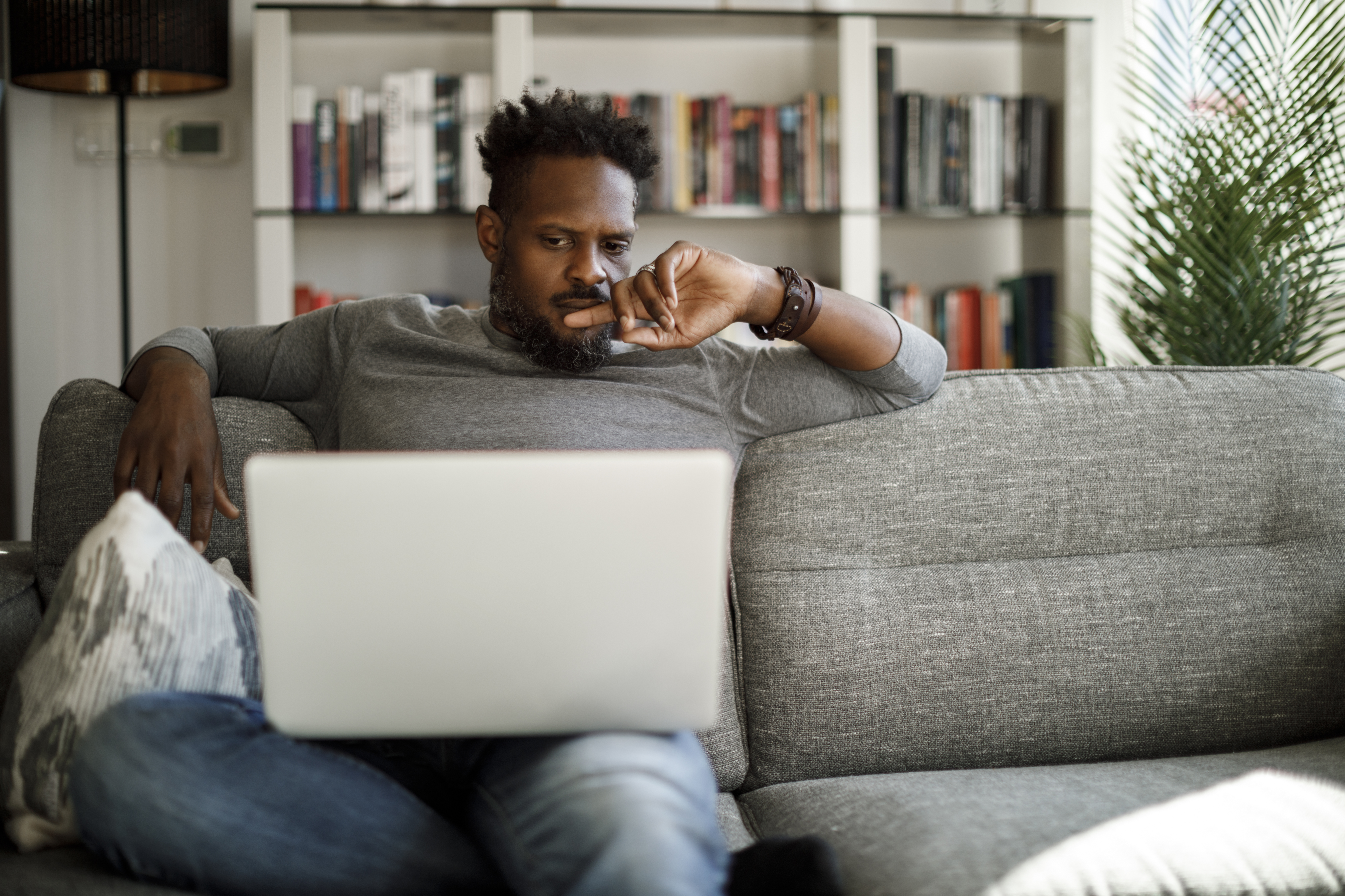 A young man looking at a computer.