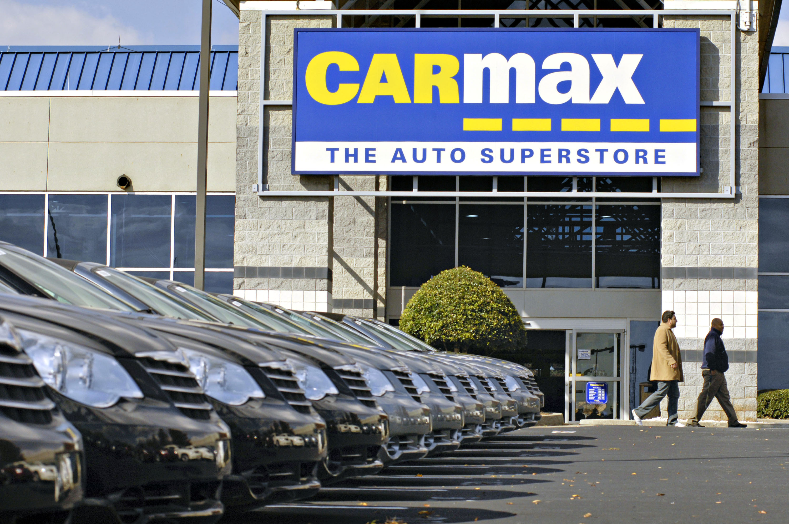 A customer walks past a Carmax.